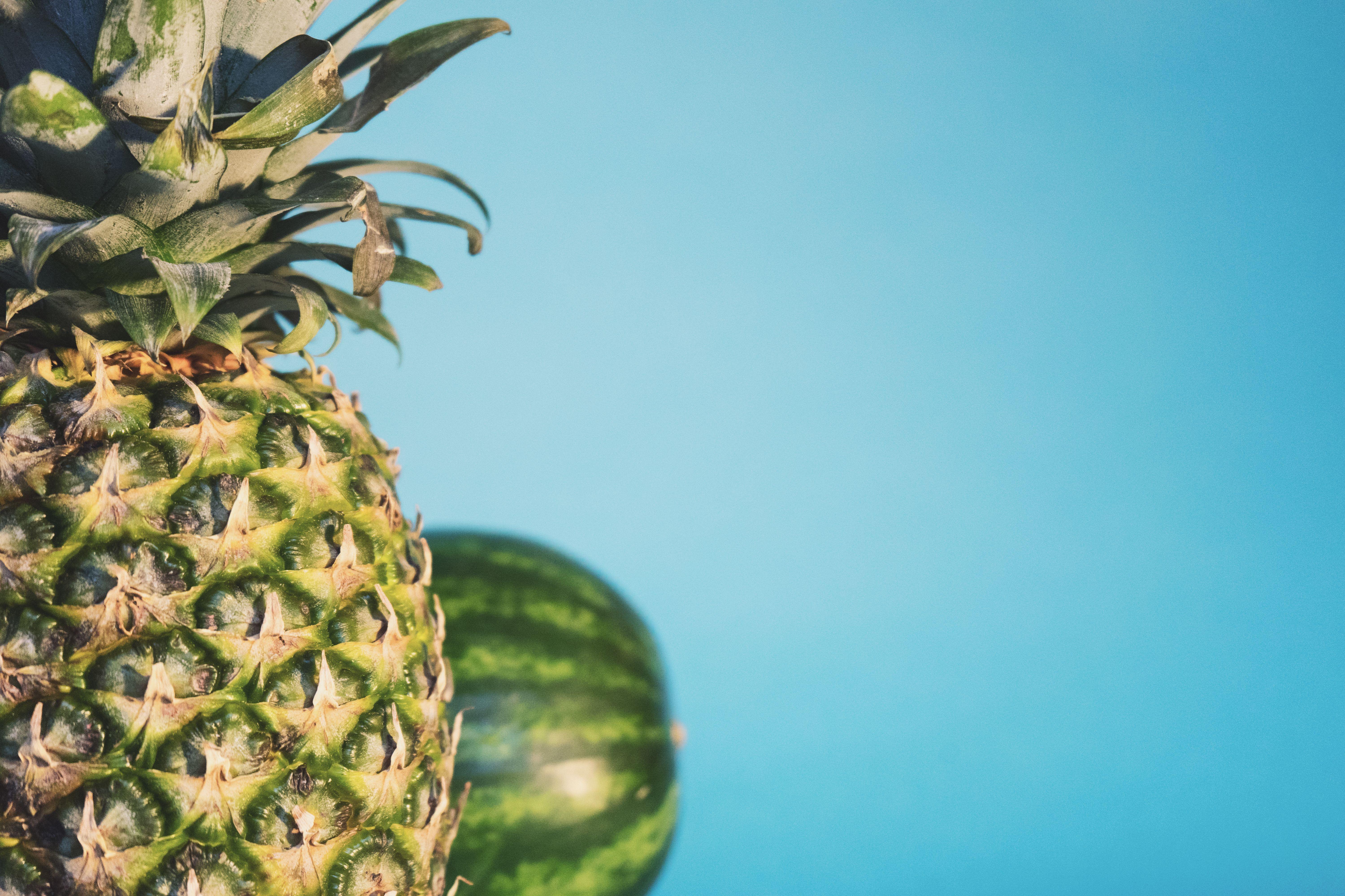 6000x4000 pineapple with watermelon on the background photo