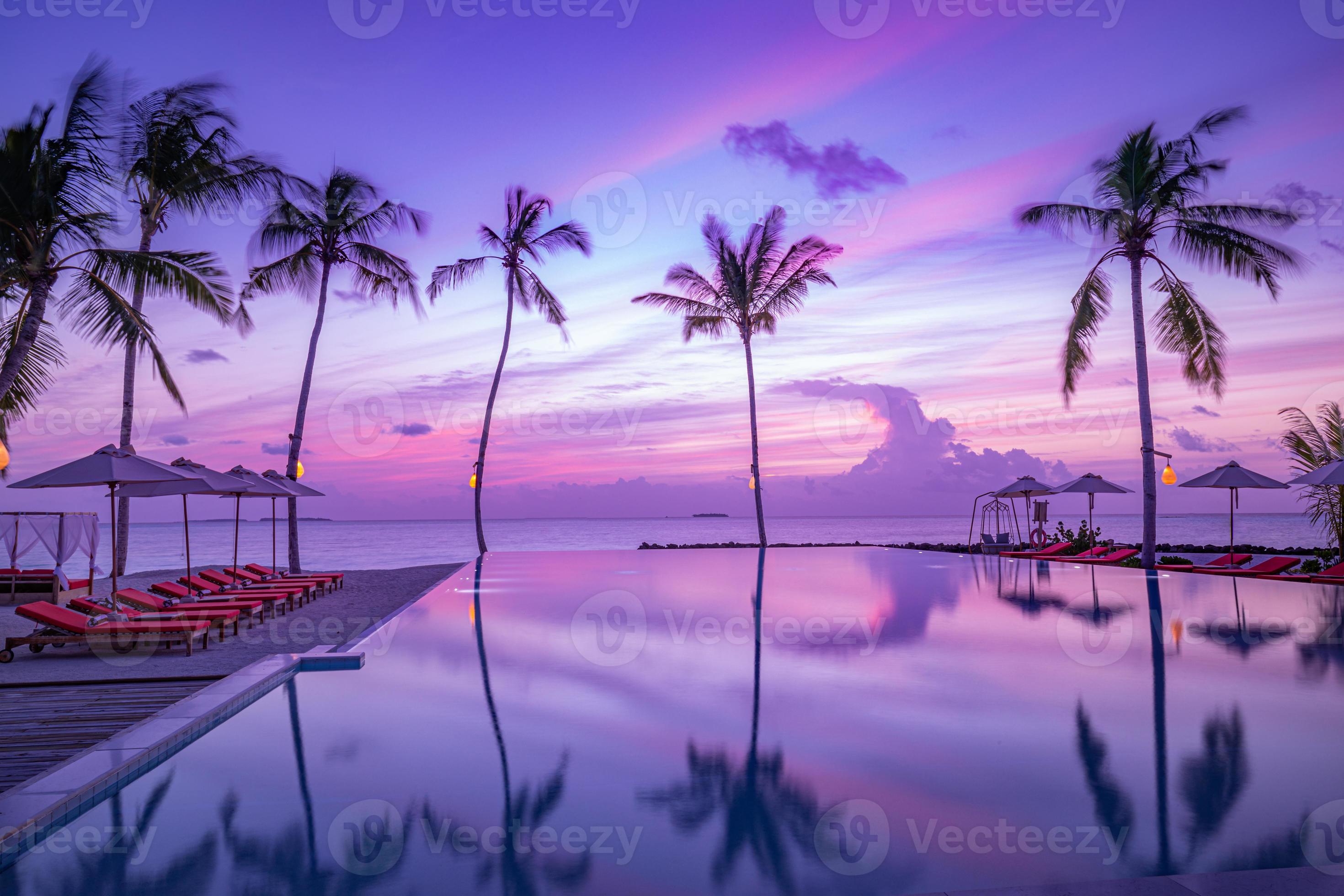 2940x1960 Luxury sunset over infinity pool in a summer beachfront hotel resort at beautiful tropical landscape. Tranquil beach holiday vacation background. Amazing island sunset beach view, palms swimming pool 13485781