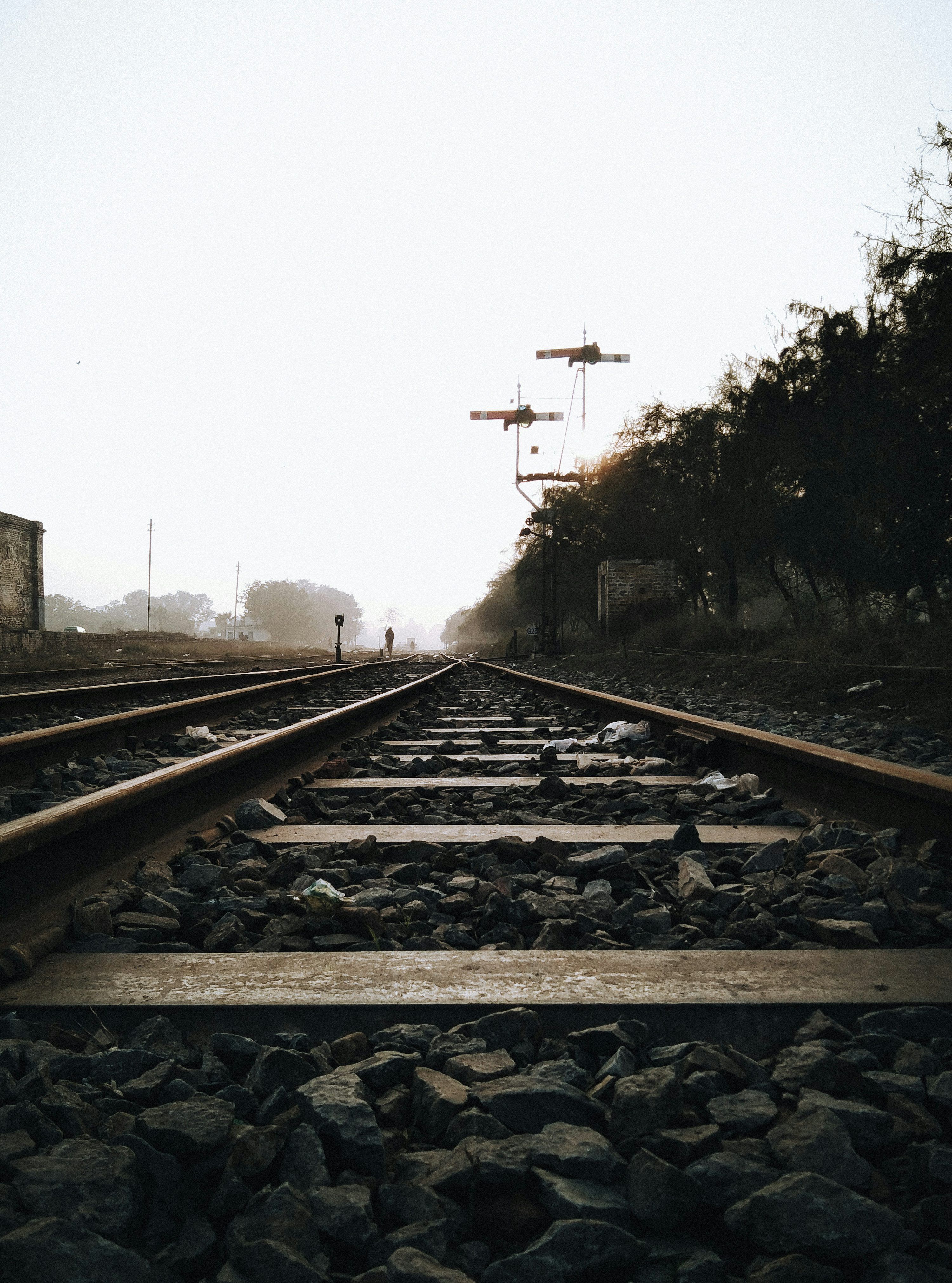 3000x4040 A train track with a person standing on it photo