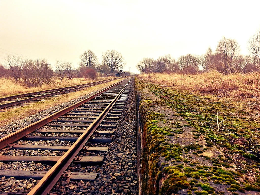 1024x768 A view of a train track from the side of the tracks. Rail