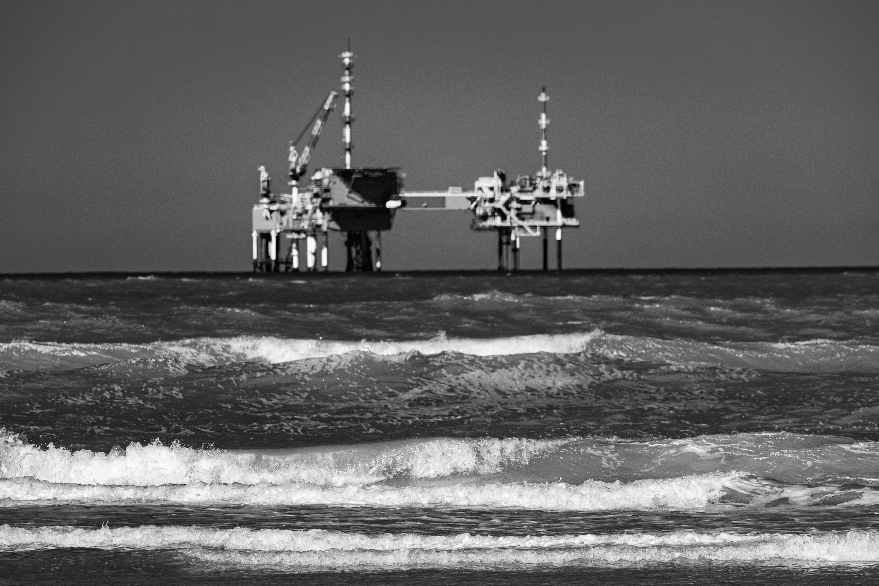 3000x2000 Offshore oil rig in rough black and white ocean. photo