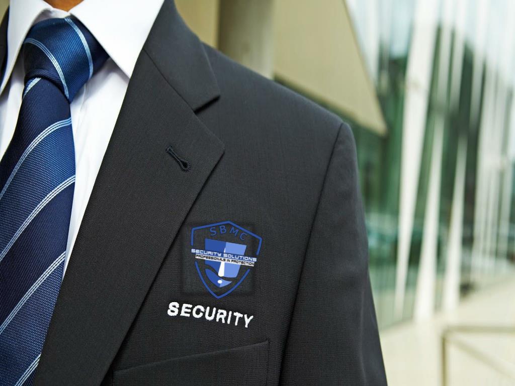 Security Guard Listens To Earpiece Back Of Jacket Showing Stock Photo   Download Image Now  iStock
