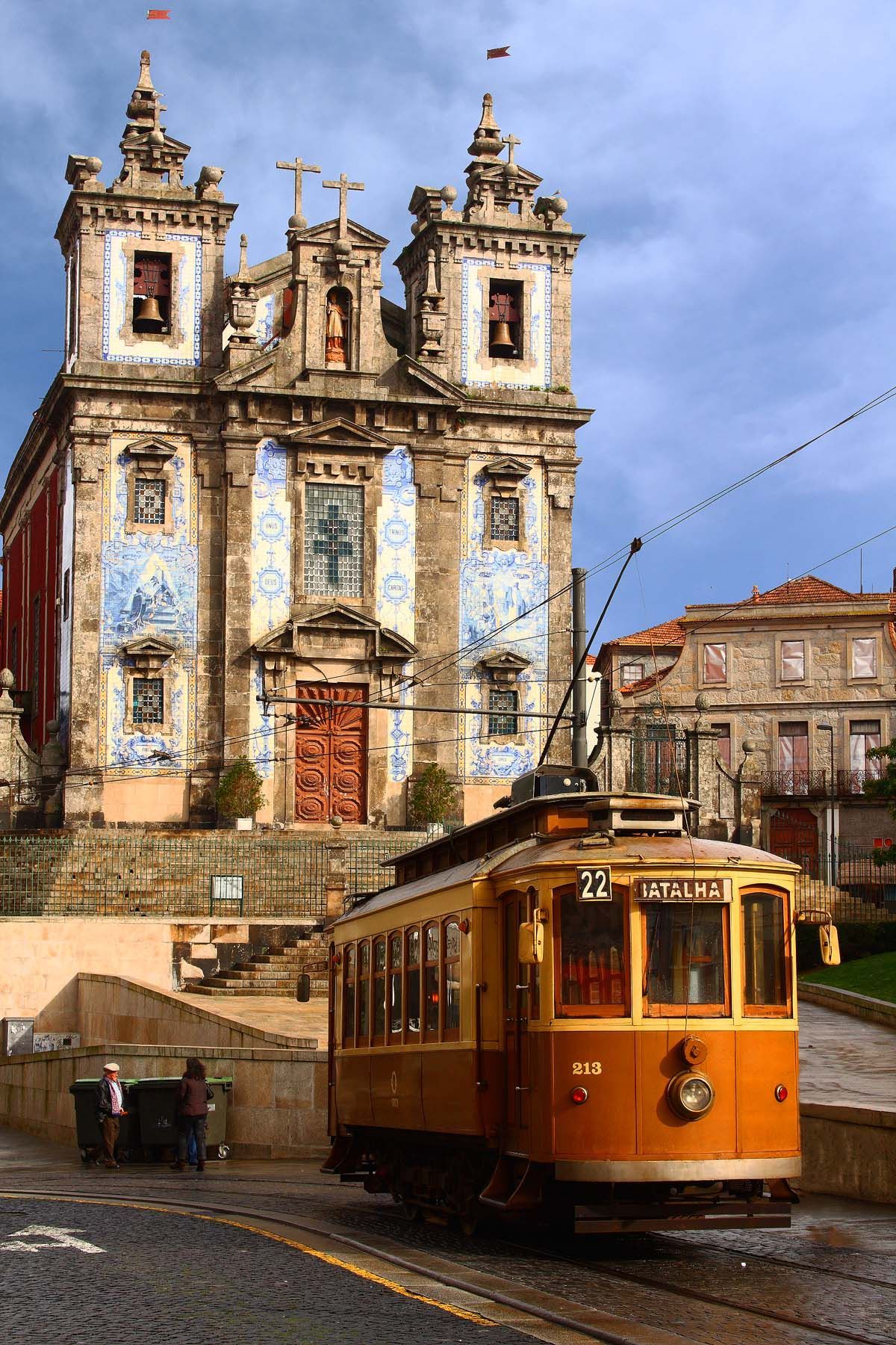 1200x1800 Wallpaper Treaty Oak Revival Sign An Orange Trolley Car Traveling Down A Street Next To A
