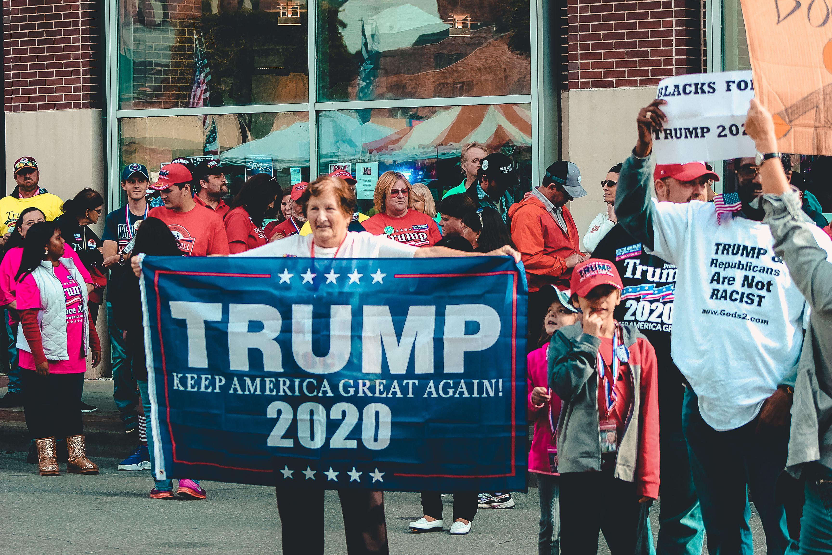 3456x2304 Woman Holding Trump Keep America Great Again 2020 Banner · Free