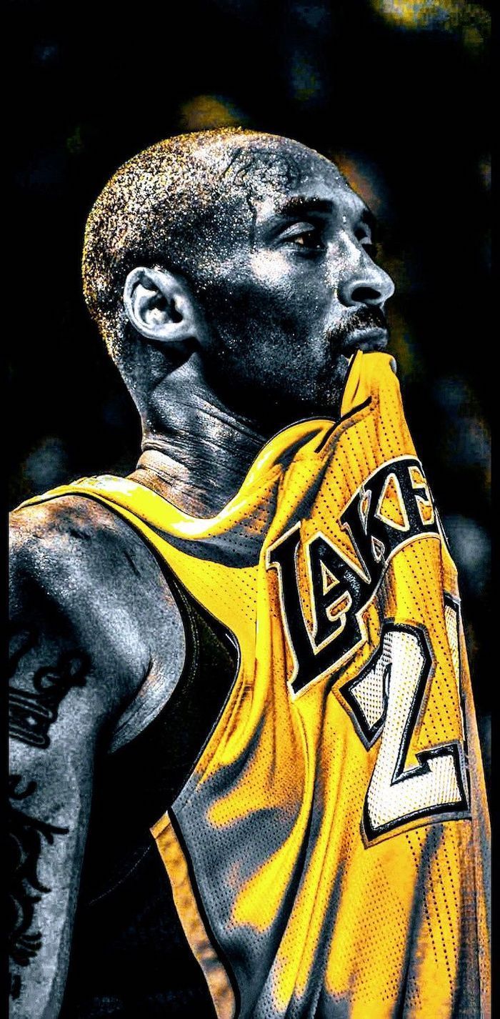 700x1426 lakers wallpaper black and white photo of kobe wearing yellow lakers jersey biting it sweat dripping