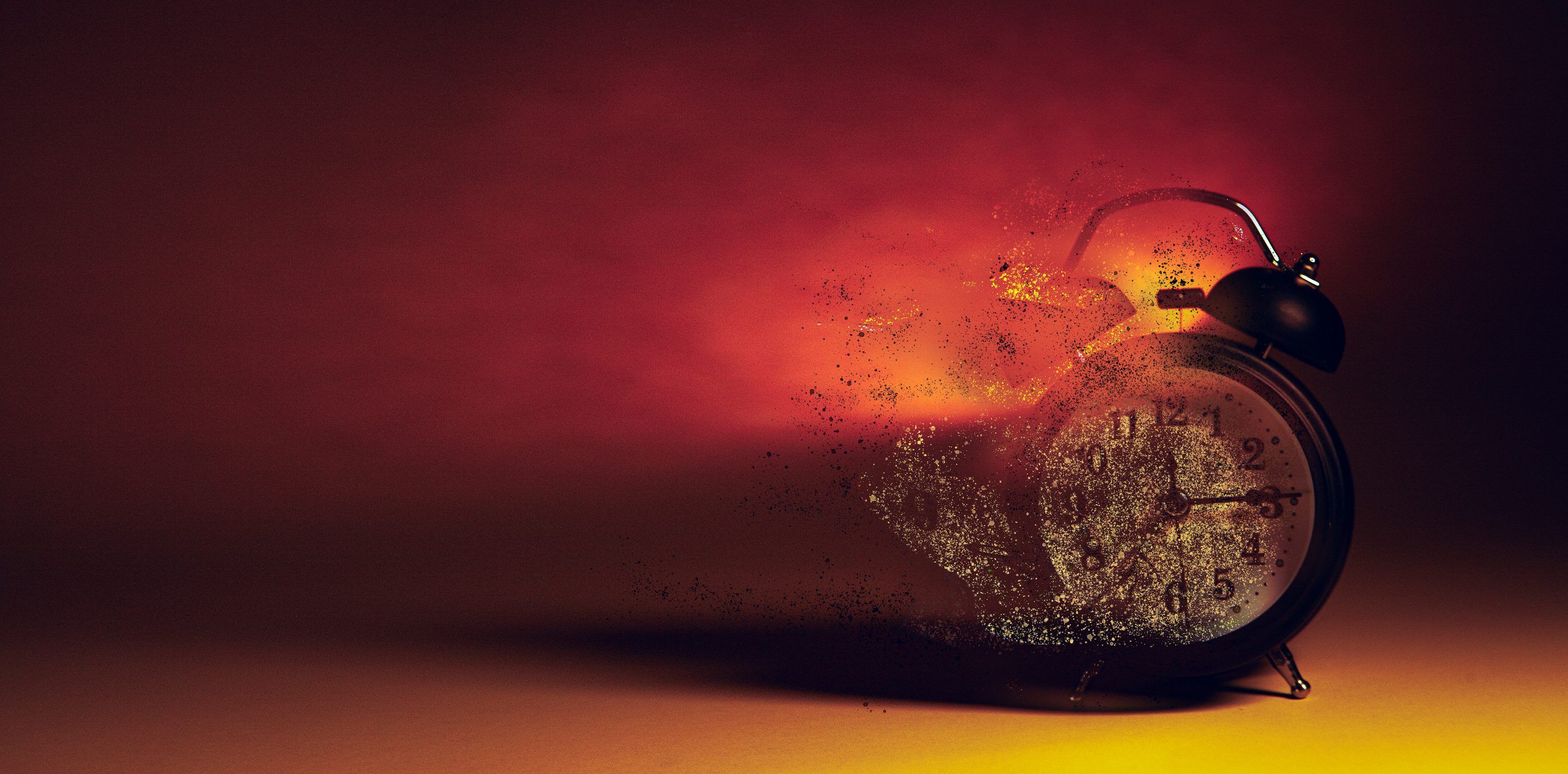 3000x1481 Alarm clock disintegrating into smoke and embers. photo