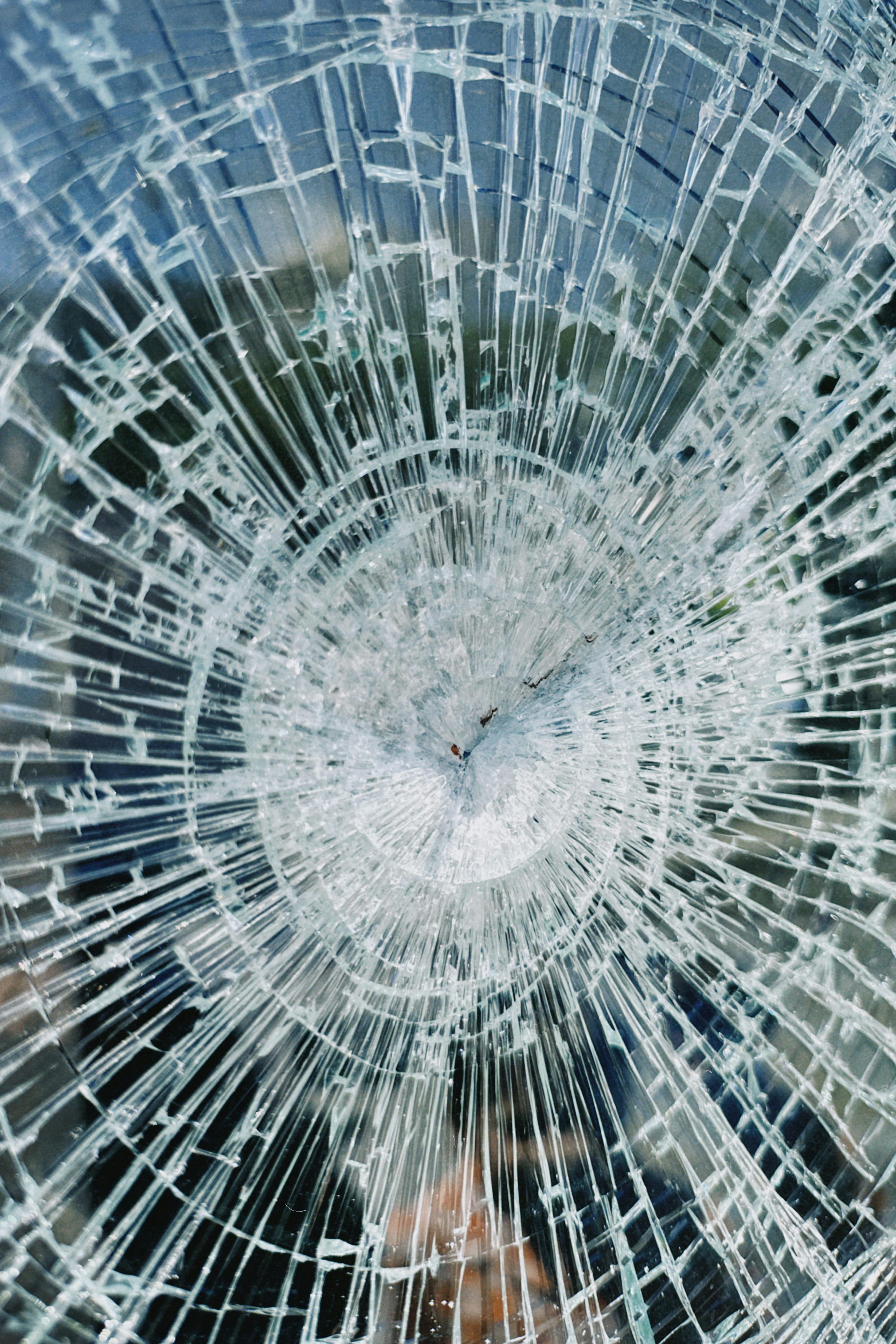 3000x4500 A broken glass window with a clock on it