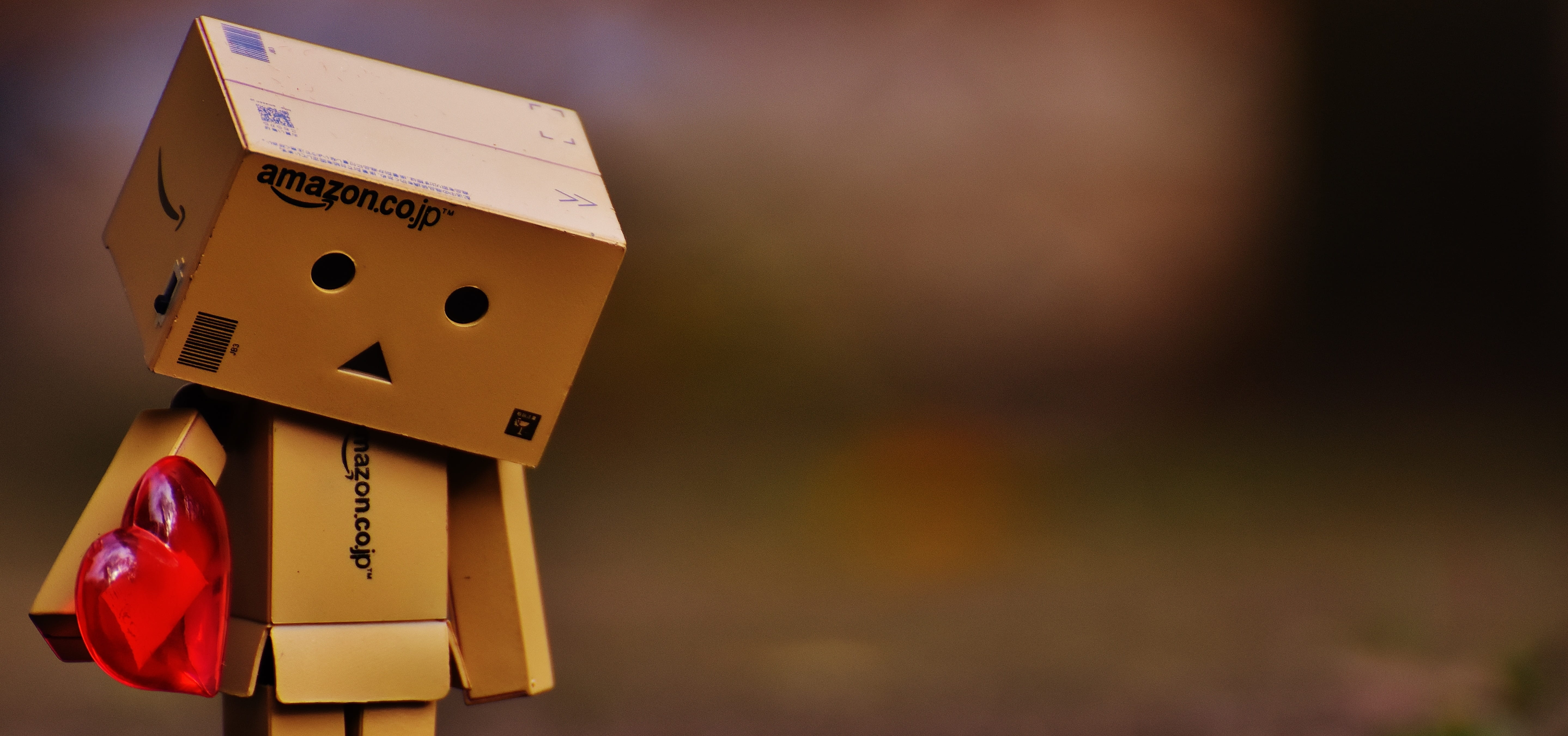 5755x2701 Royalty Free Photo: Selective Focus Photography Of Boxman Holding Heart
