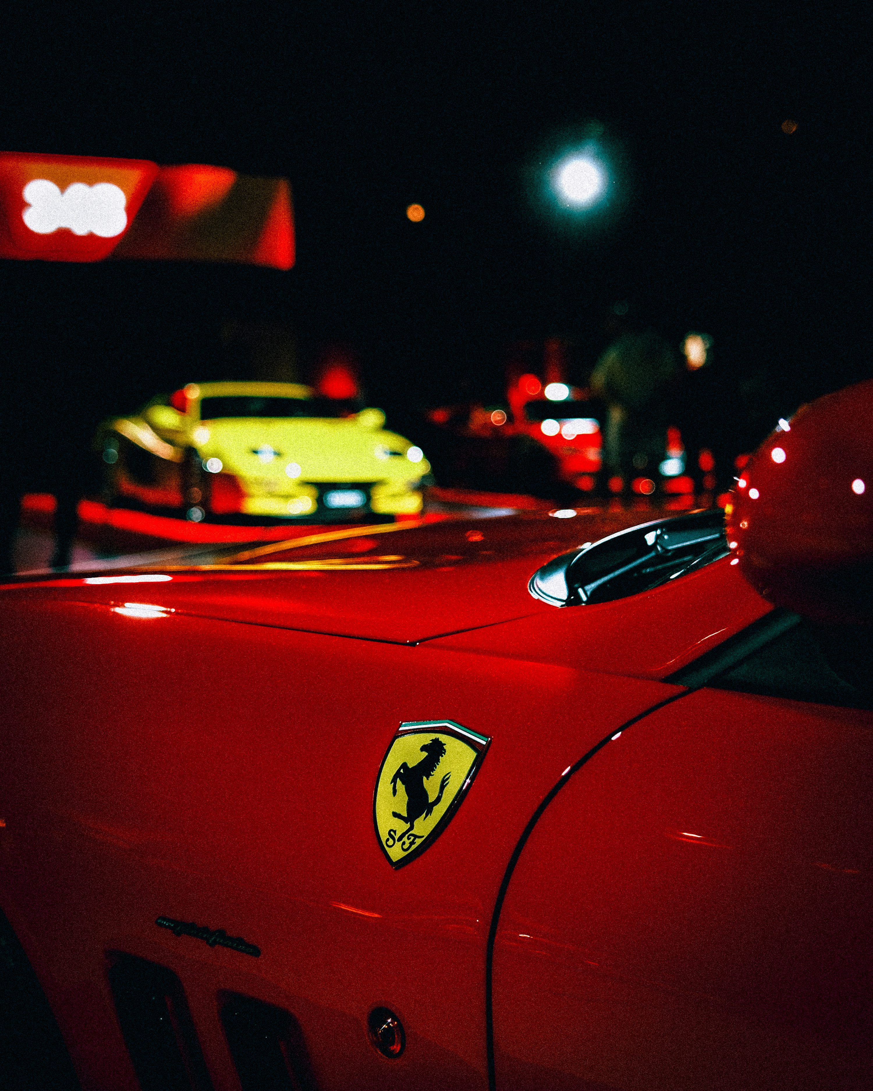 3000x3750 A red ferrari with others at night. photo