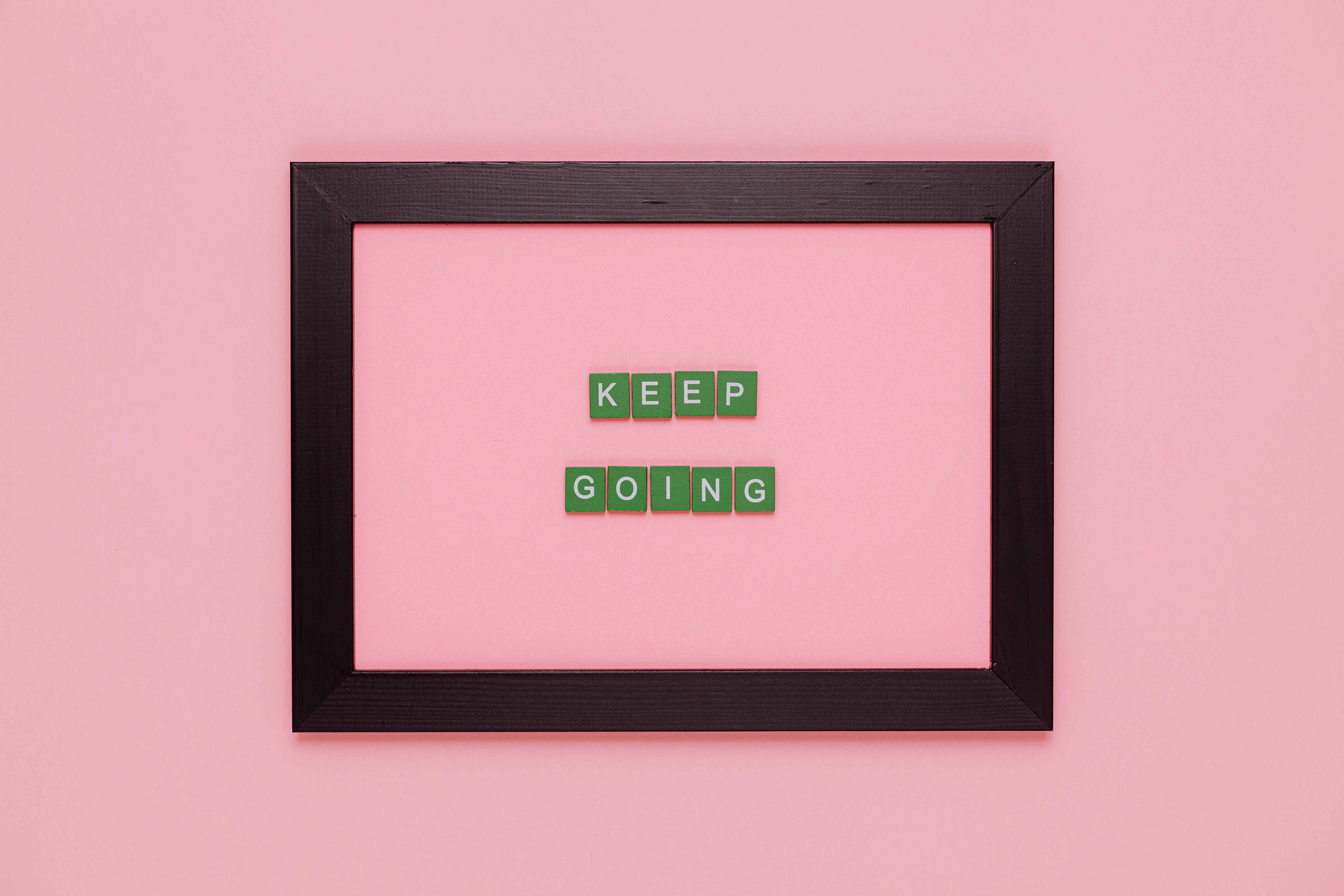 6648x4432 A Text Saying Keep Going in a Frame on Pink Background · Free