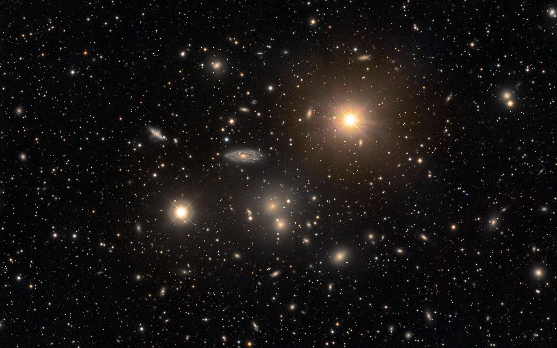 1920x1200 The Hydra Cluster of Galaxies. Two stars within our own Milky Way galaxy anchor the foreground of this cosmic snap. Galaxies, Milky way galaxy, Astronomy picture