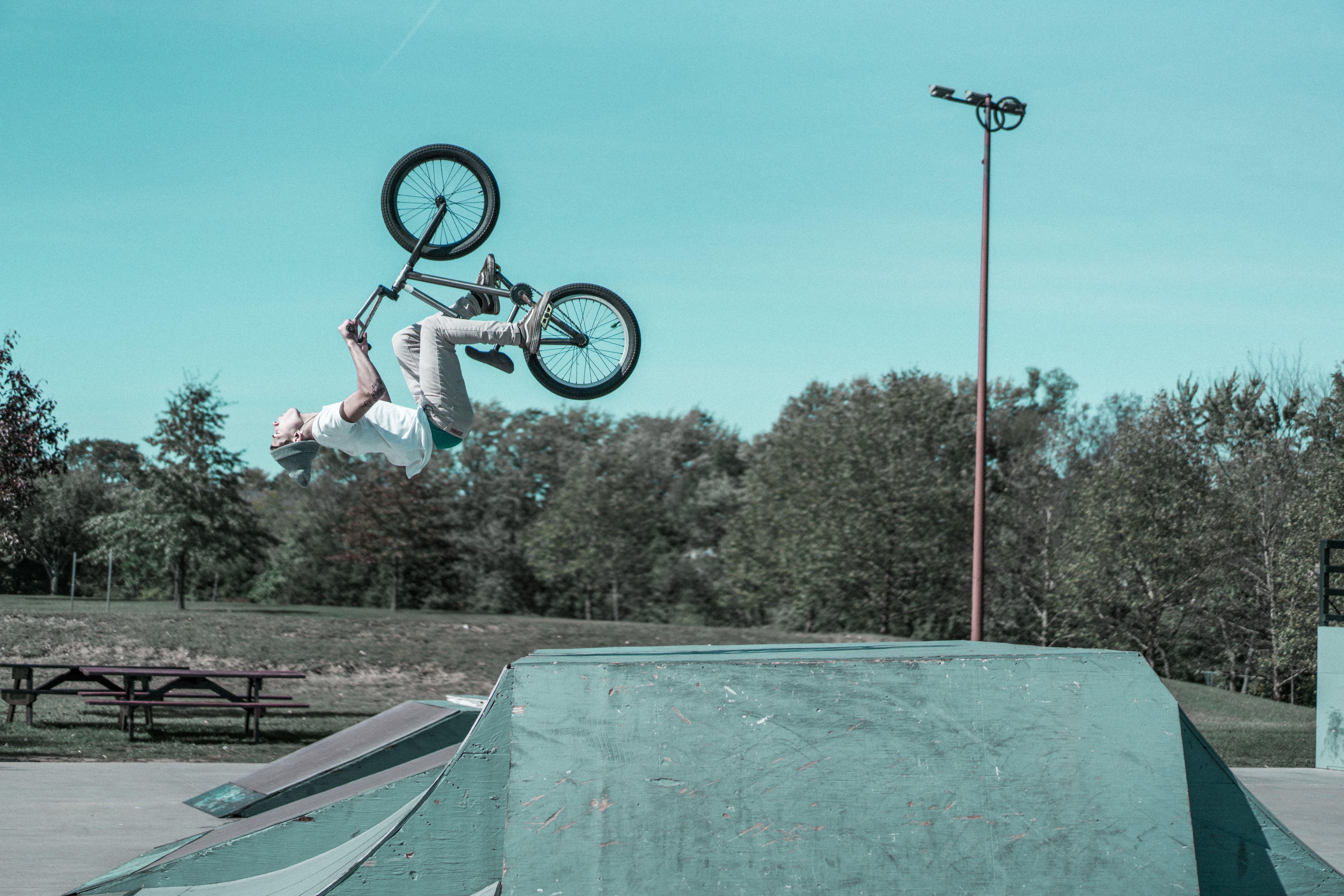 7952x5304 man doing BMX bike stunts photo