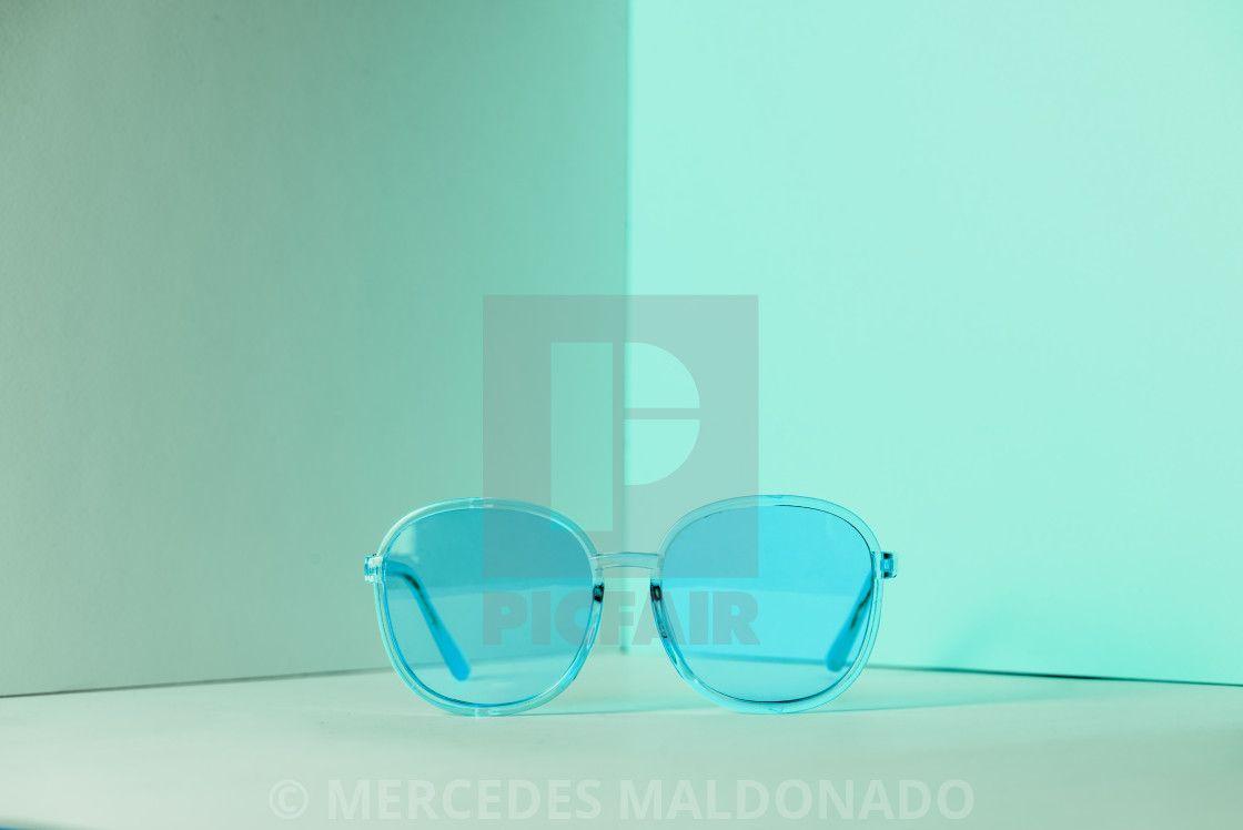 1120x748 Stylish blue sunglasses on modern minimal pastel background, front view. Nobody. Product photograph, download or print for £12.40