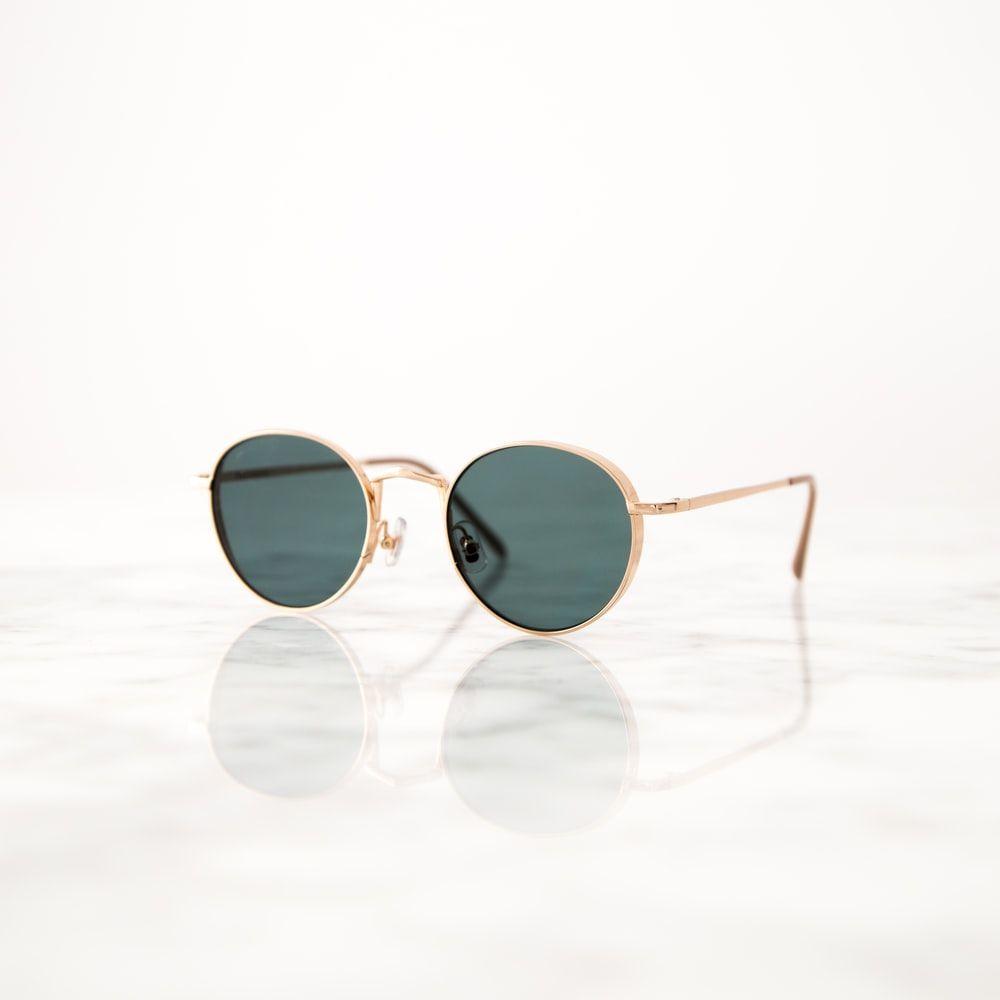 1000x1000 Gold Colored Framed Hippie Sunglasses On White Surface Photo
