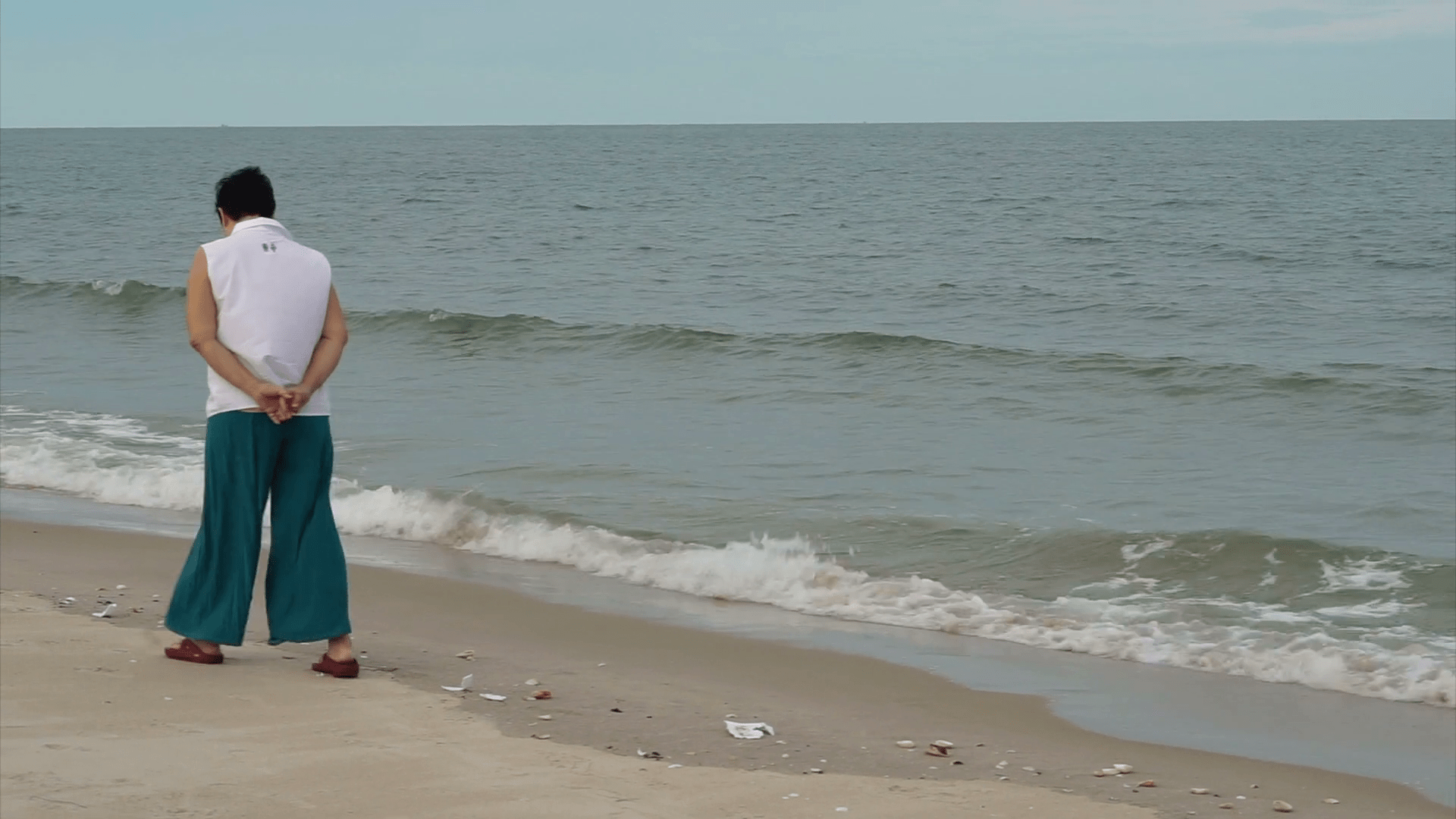 1920x1080 Asian senior woman walking alone along the beach enjoying nature Stock Video Footage