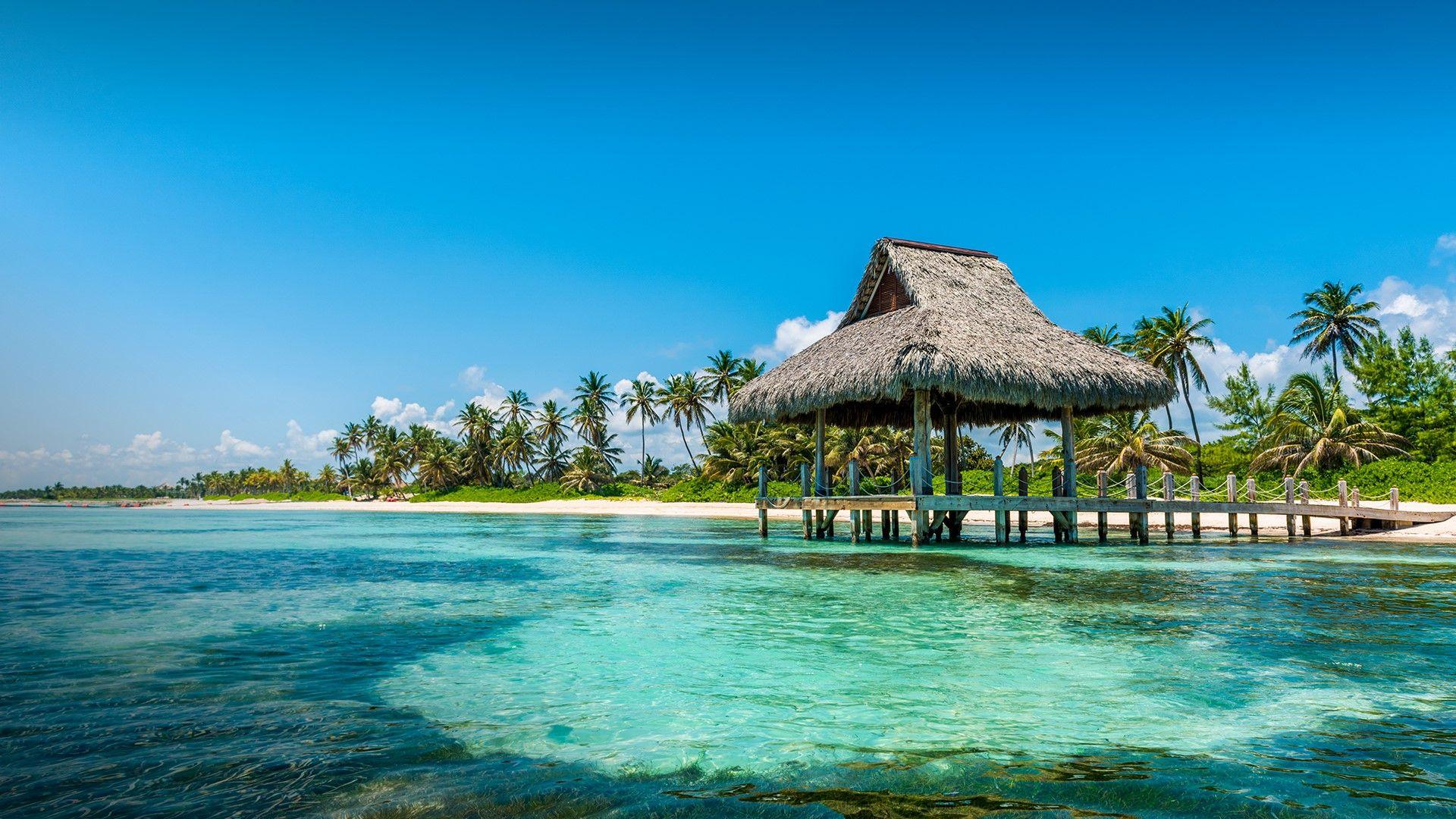 1920x1080 Thatched beach hut at Playa Blanca, Punta Cana, La Altagracia, Dominican Republic. Windows 10 Spotlight Image