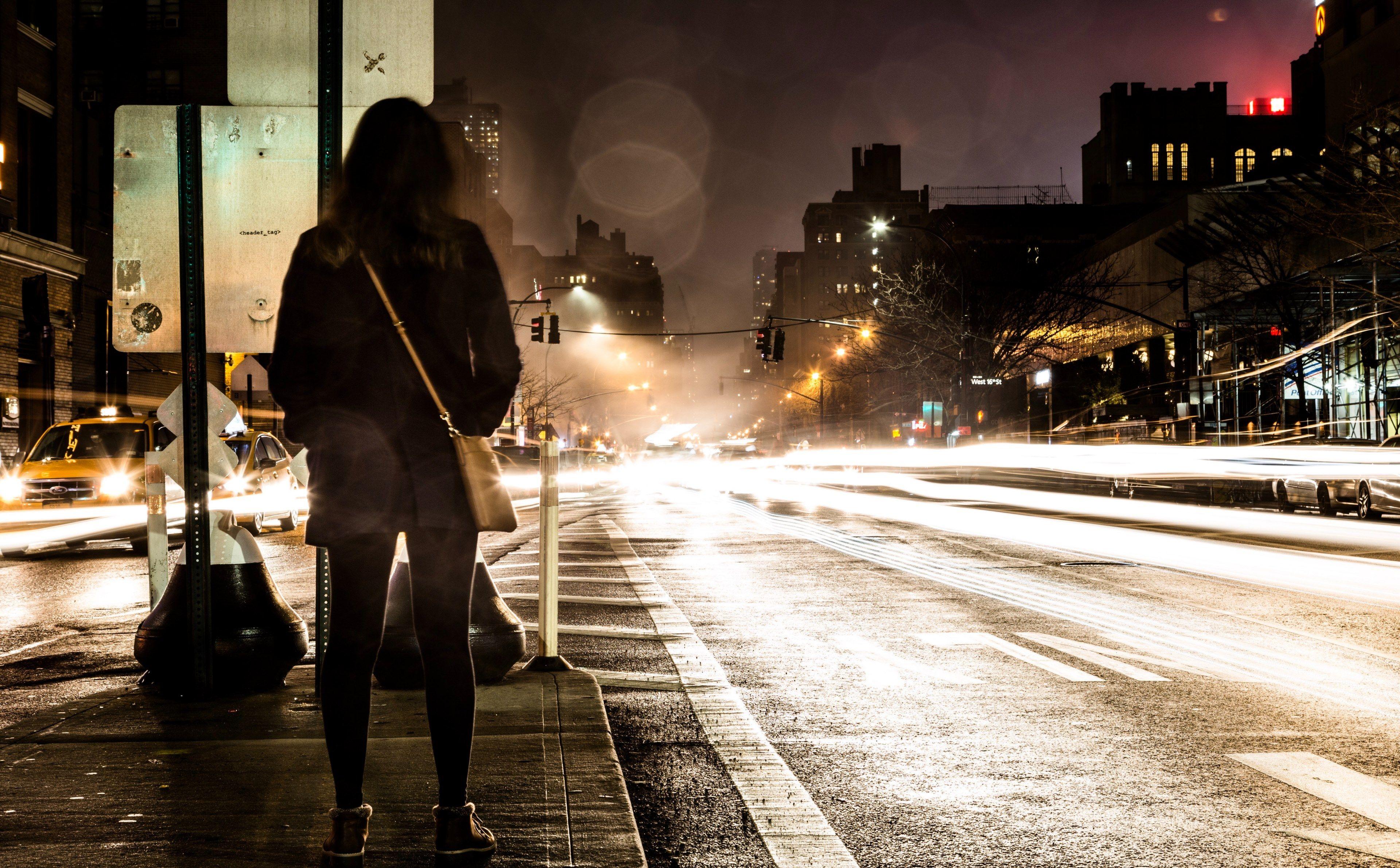3840x2382 Wallpaper / a woman with a leather bag waiting to cross the street in new york at night, nyc rain 4k wallpaper