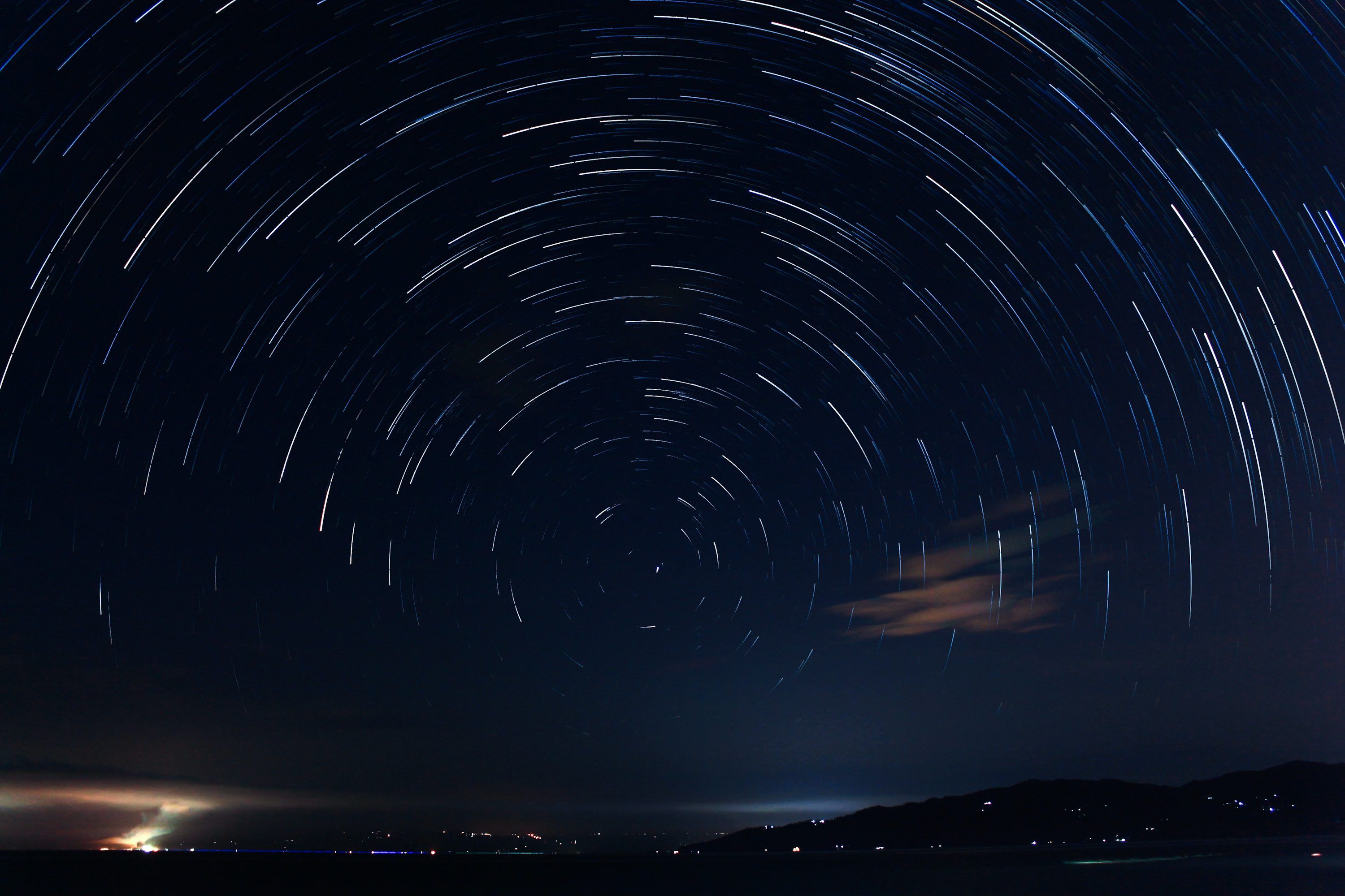 3000x2000 A star trail over a body of water