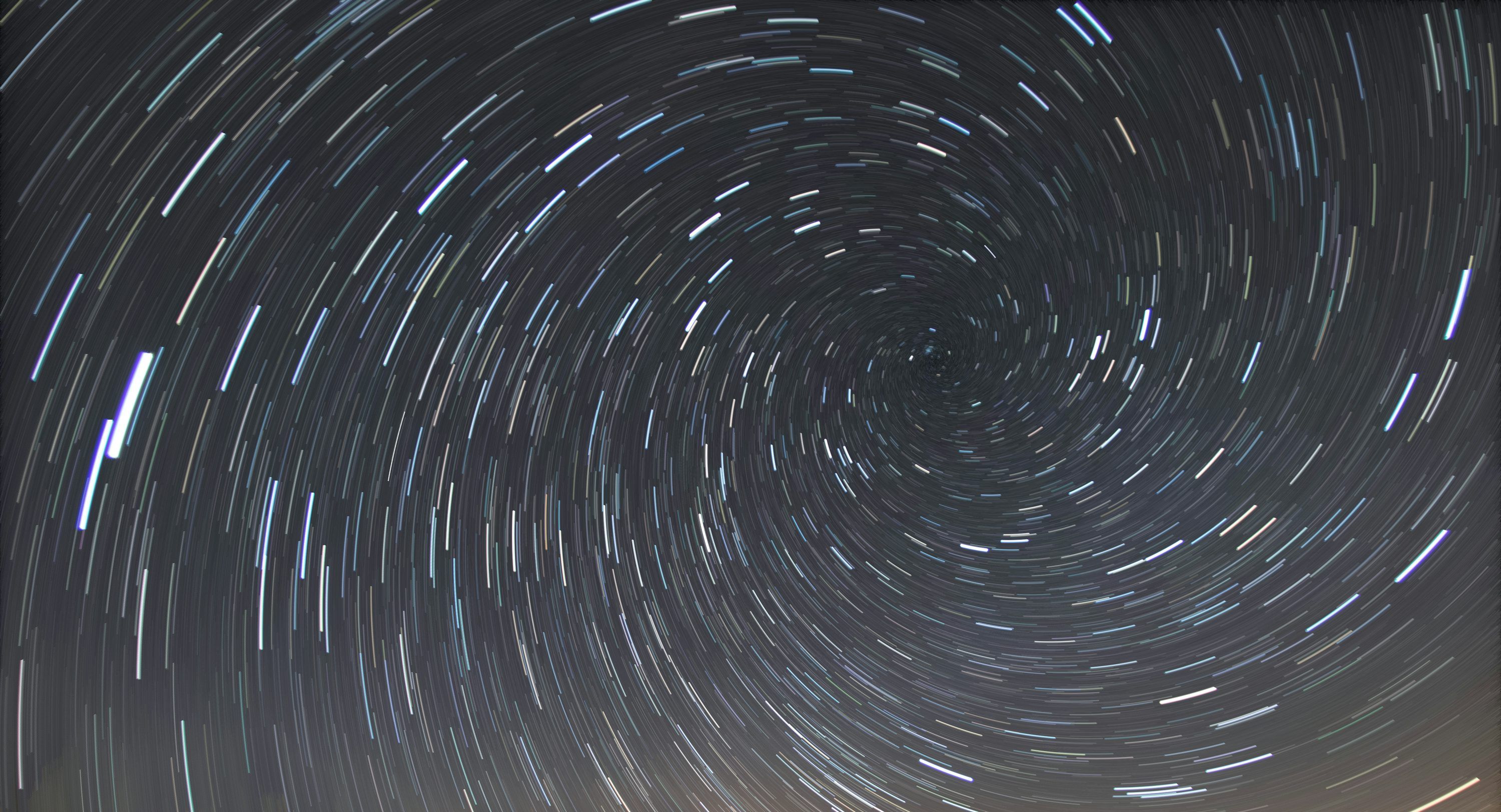 3000x1624 A star trail is seen in the night sky photo