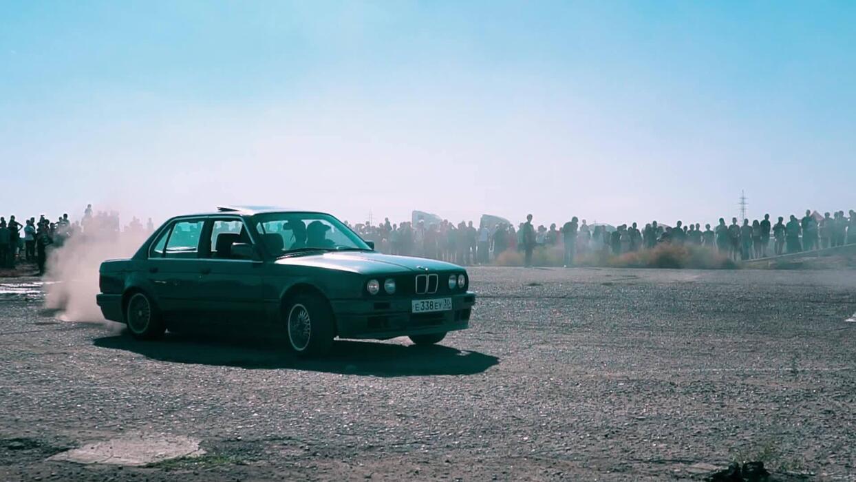 1244x700 Drifting car, professional driver drifting car on asphalt race track. smoke and dust