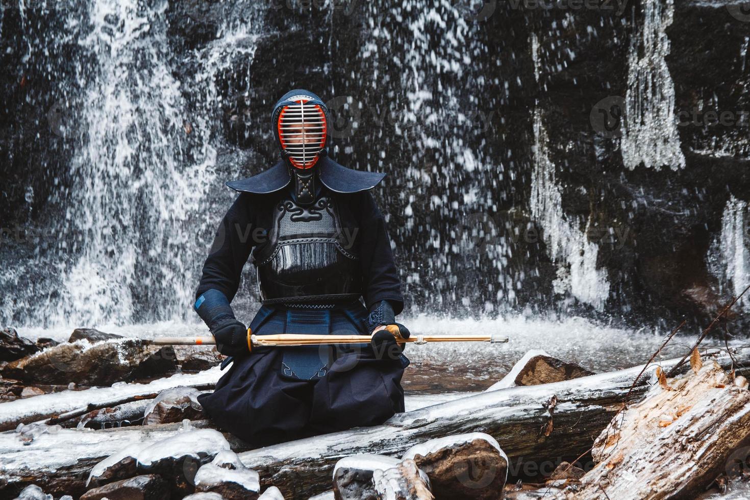 1470x980 Man practicing kendo with bamboo sword on waterfall background