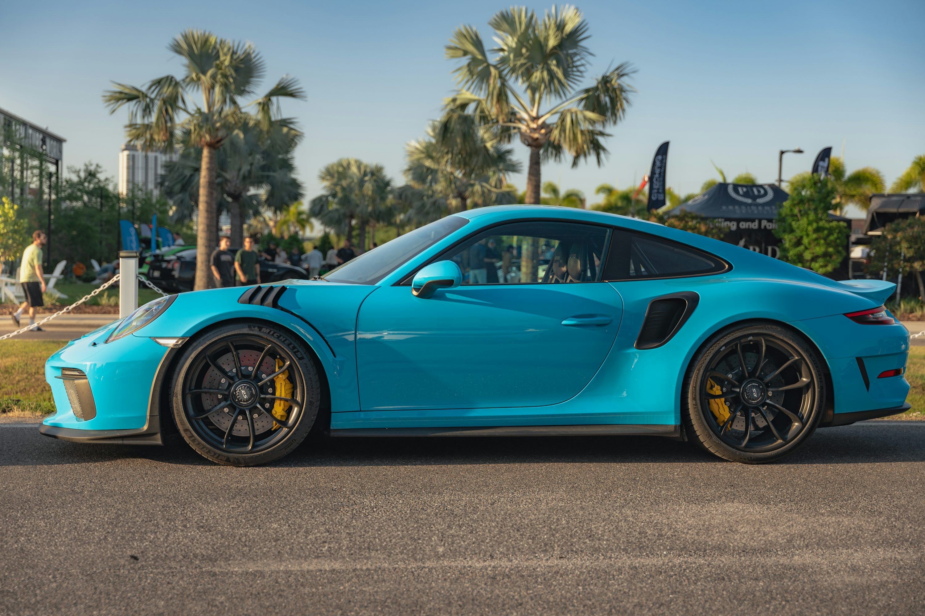 3000x2000 A bright blue porsche car is parked. photo