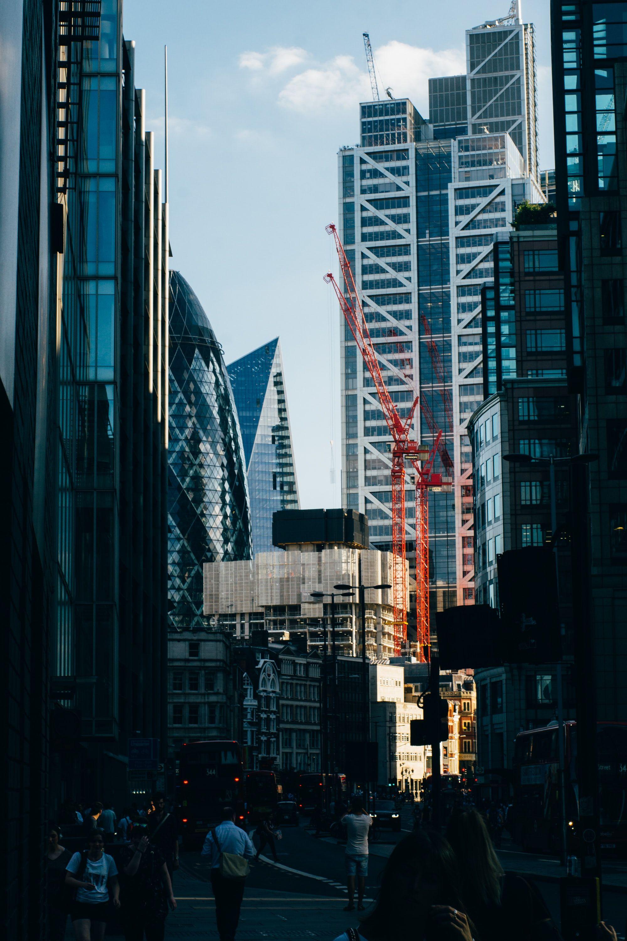 1999x2999 selective focus photo of crane near glass buildings photo