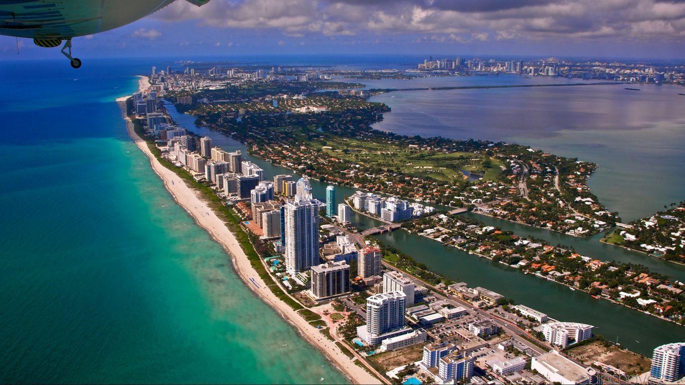 1366x768 Download wallpaper 1366x768 miami, city, flight, view from the height of, ocean tablet, laptop HD background