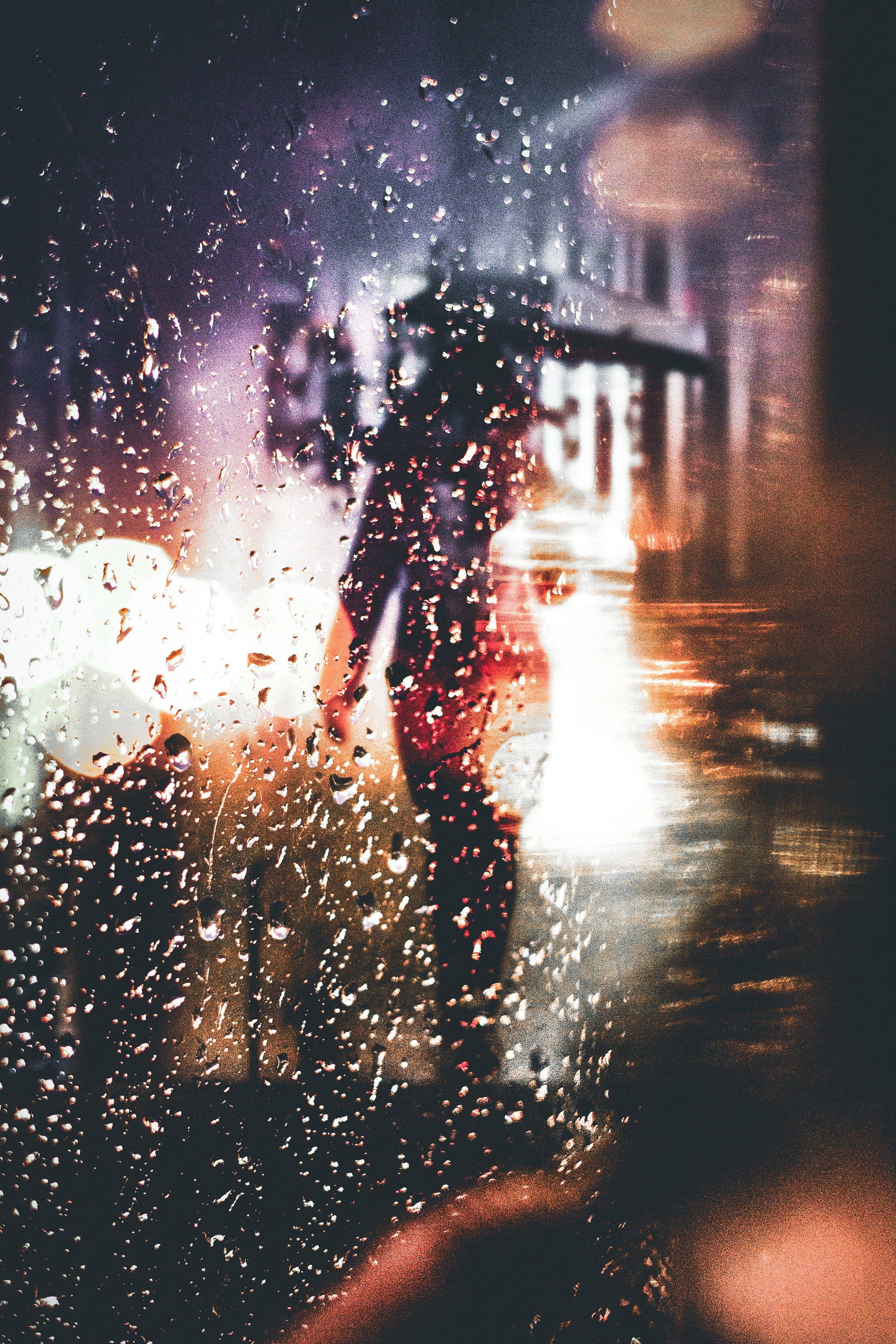 2735x4102 Wallpaper / silhouette of a person with an umbrella walking in the rain during night time in melbourne, person rain melbourne 4k wallpaper