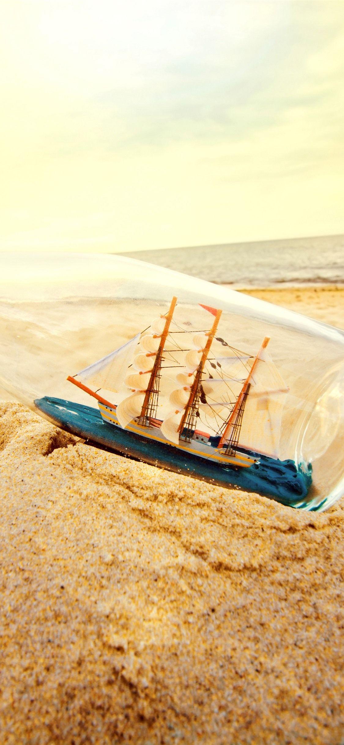 1125x2436 Sand, Bottle, Beach, Ship Model, Sea 1242x2688 IPhone 11 Pro XS Max Wallpaper, Background, Picture, Image