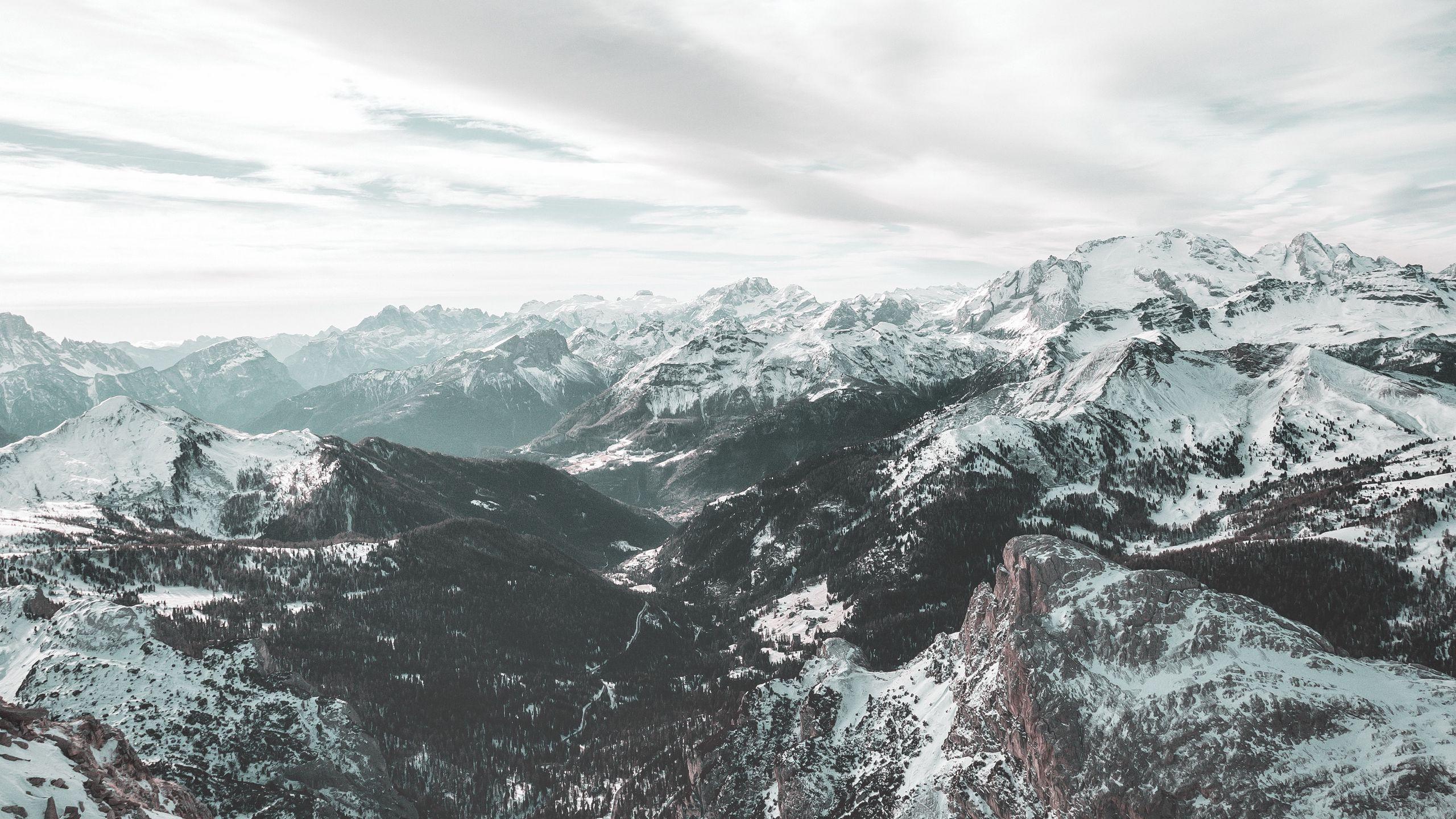 2560x1440 Download wallpaper 2560x1440 winter, snow, mountains, aerial view, dolomites, italy, sky, clouds widescreen 16:9 HD background