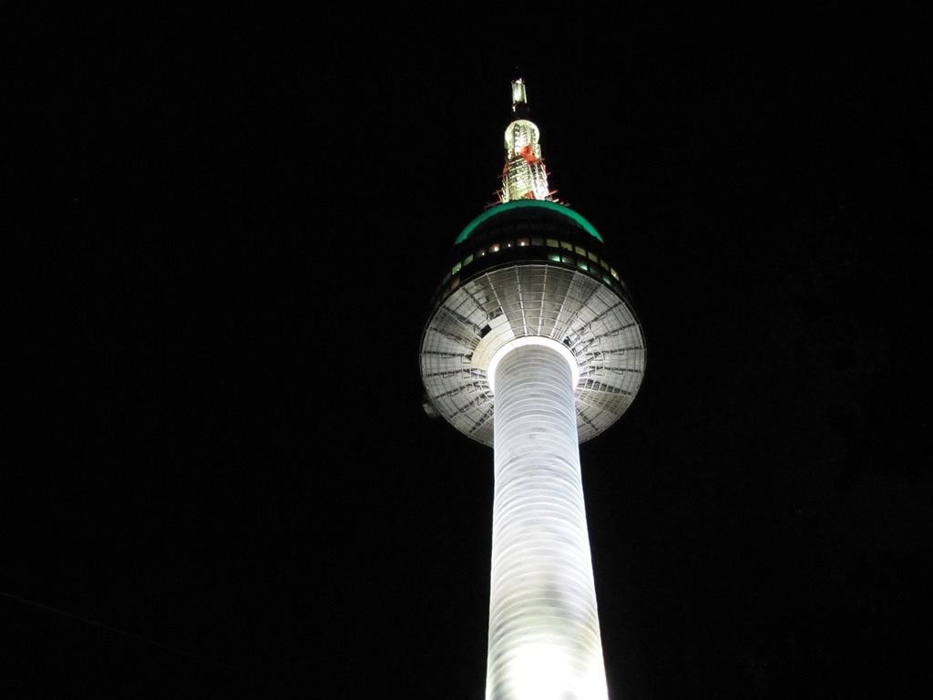 1024x768 A tall white tower lit up at night. Seoul namsan n tower