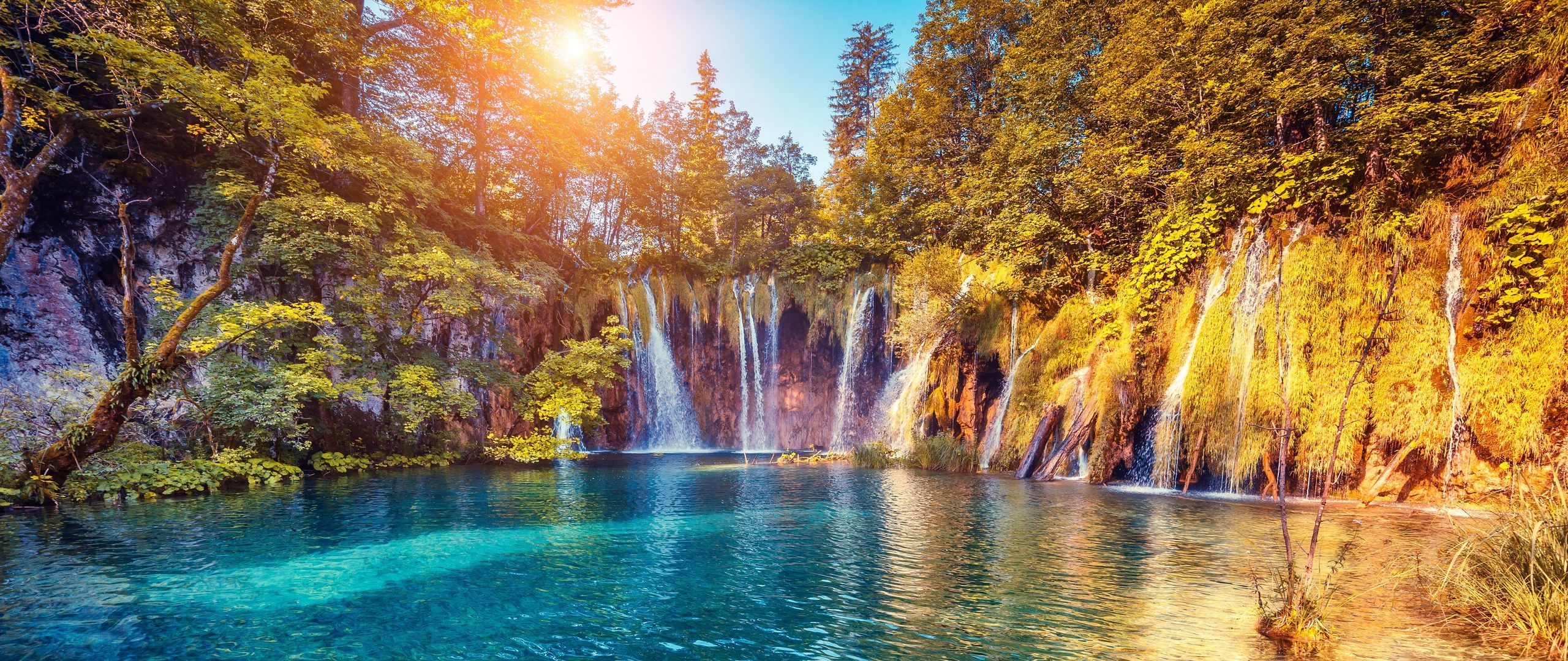 2560x1080 Download wallpaper 2560x1080 waterfall, precipice, sunlight, summer, bright, trees dual wide 1080p HD background