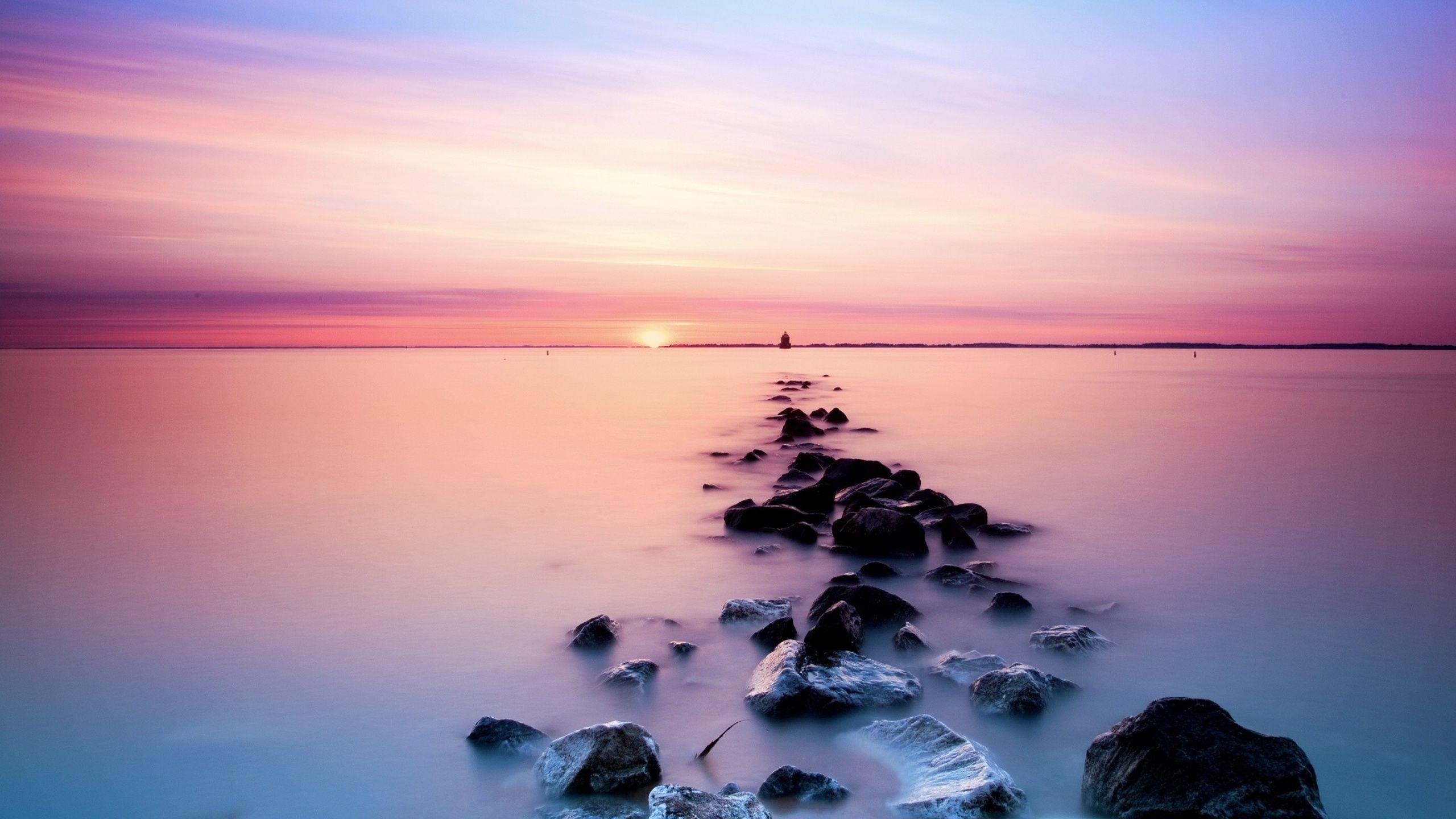 2560x1440 Pink Sky Ocean & Black Rocks desktop PC and Mac wallpaper