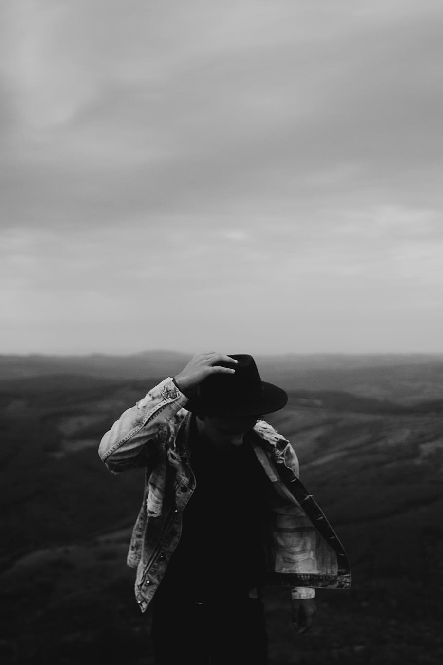 910x1365 grayscale photography, man, holding, hat, grayscale photo, walking, field, portrait