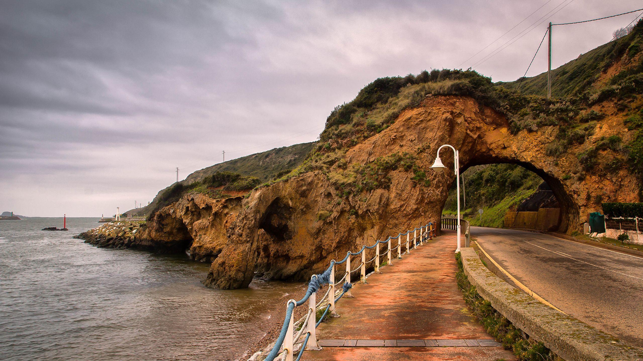 2560x1440 image Spain Aviles Asturias Crag Nature Roads Fence Coast 2560x1440
