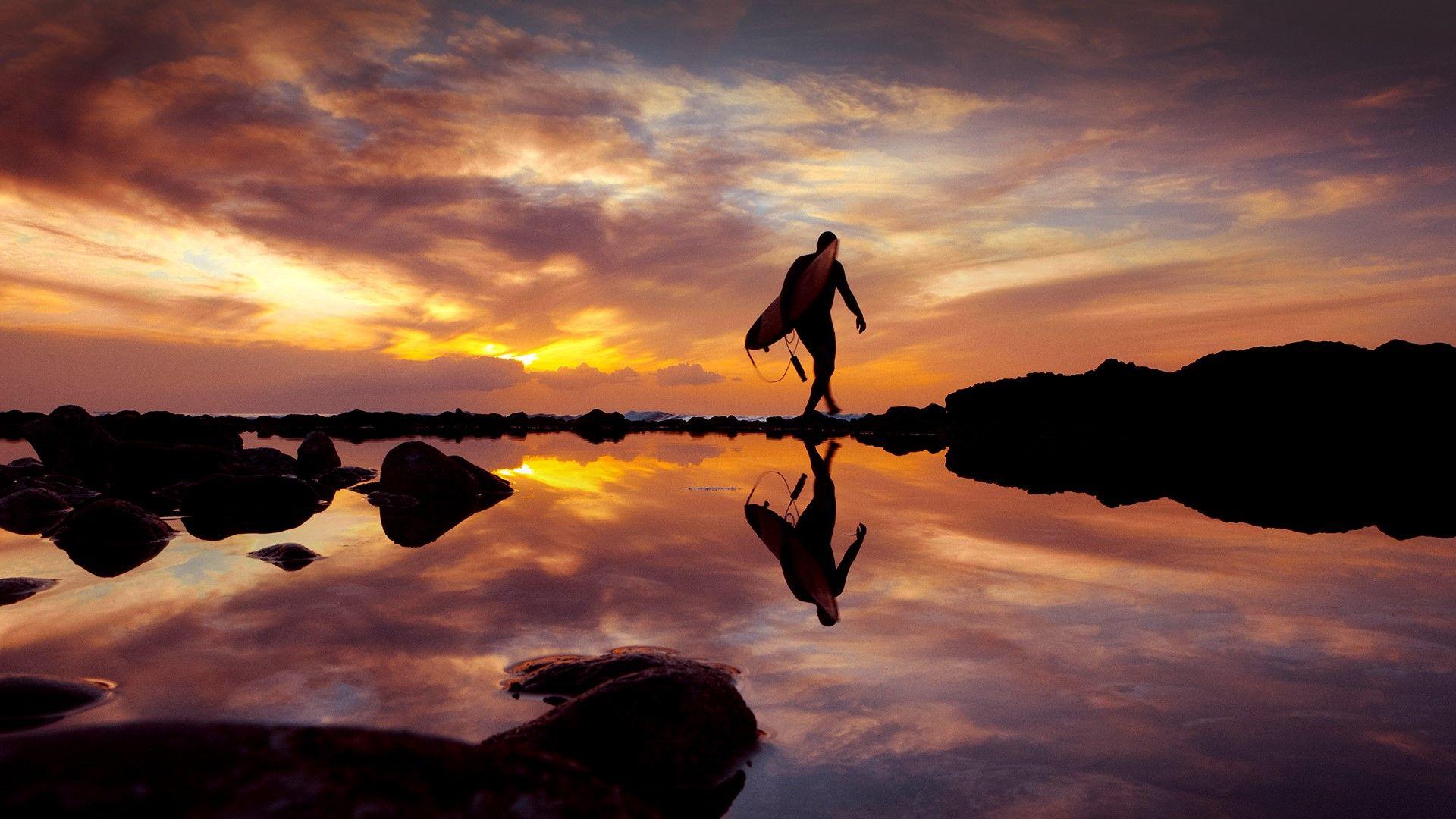 1920x1080 Surfer at sunset by the sea, Playa de las Américas, Tenerife, Canary Islands, Spain. Windows 10 Spotlight Image