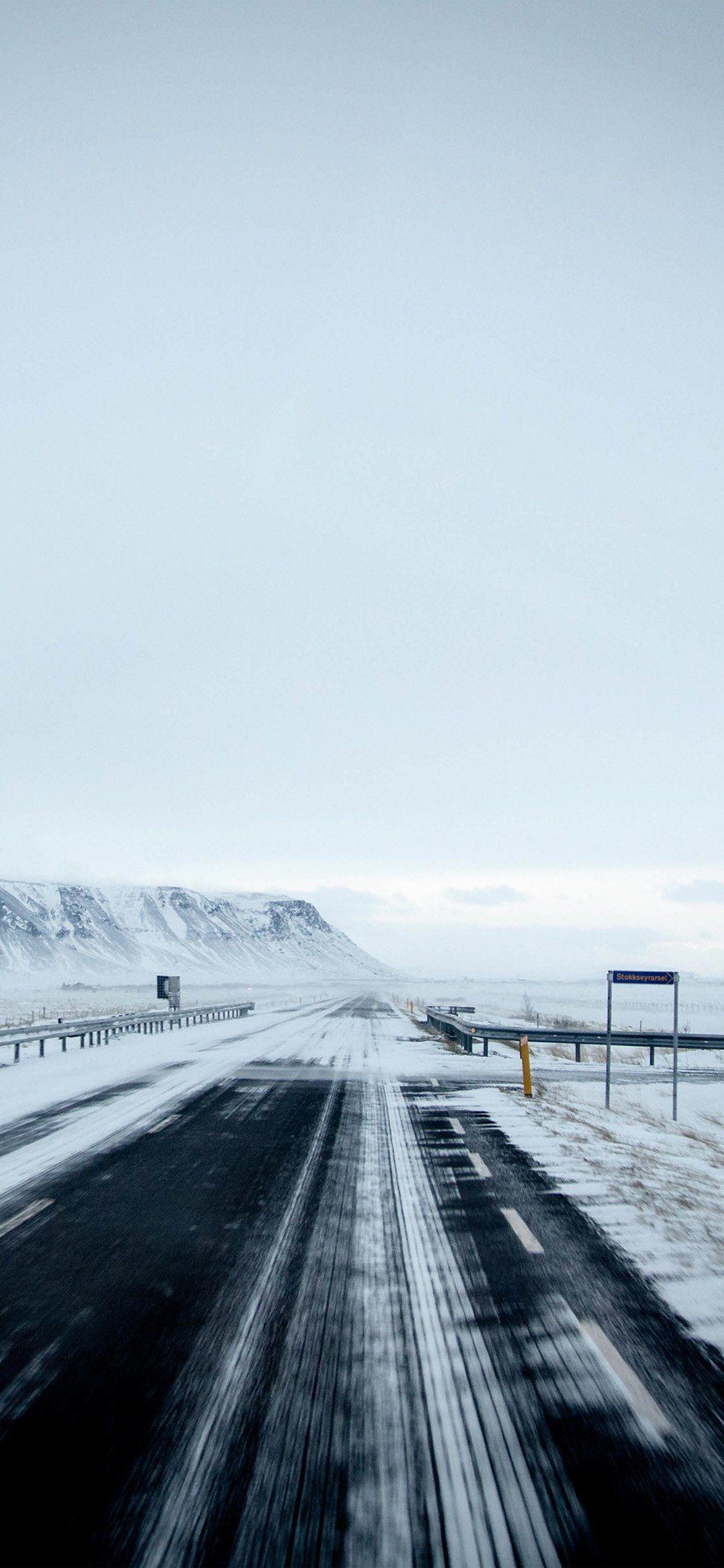 1125x2436 Winter road mountain iPhone X Wallpaper Free Download