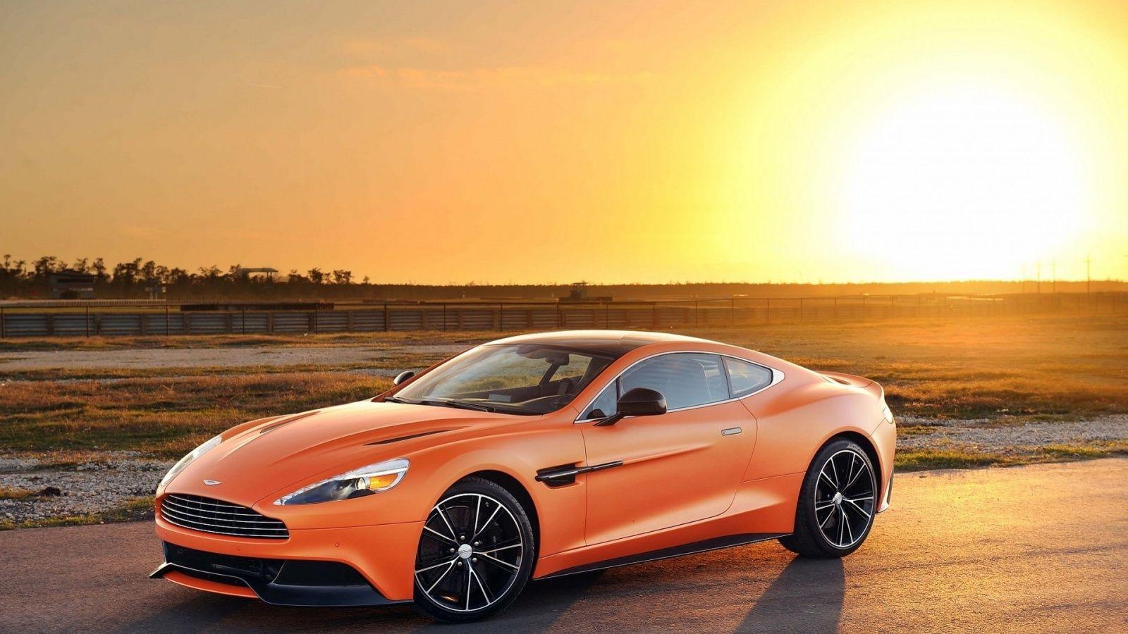 1600x900 Matte Orange Aston Martin Vanquish 2014 Wallpaper