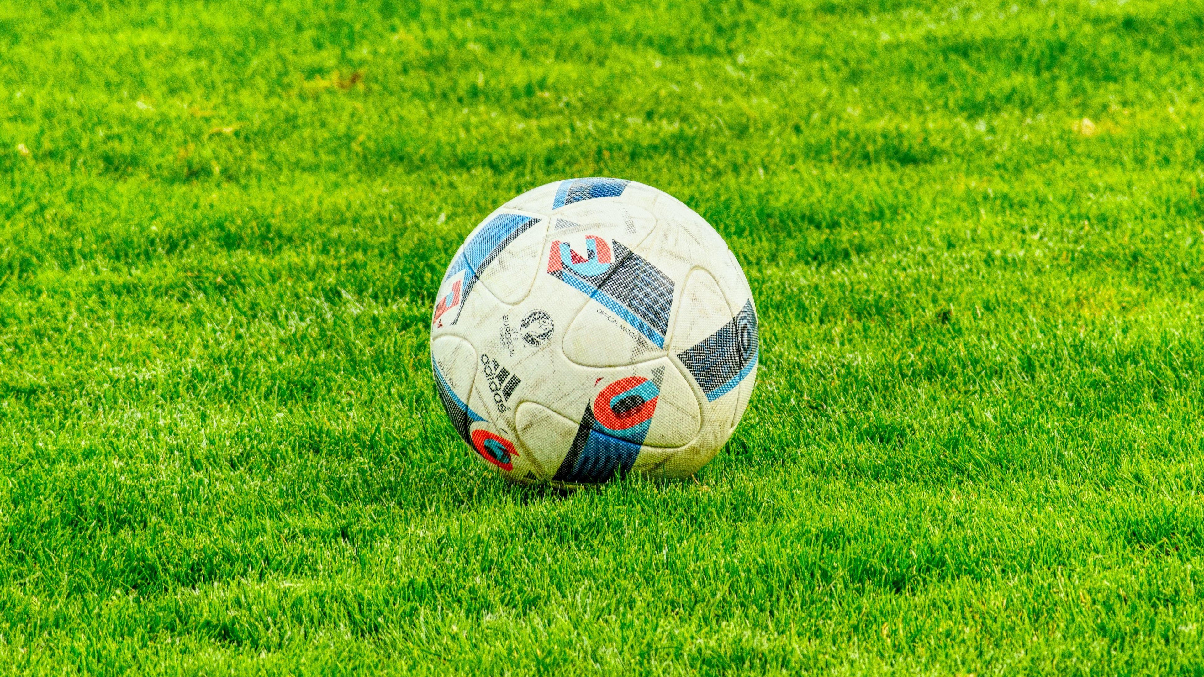 3840x2160 Download wallpaper 3840x2160 ball, football, lawn, grass 4k uhd 16:9