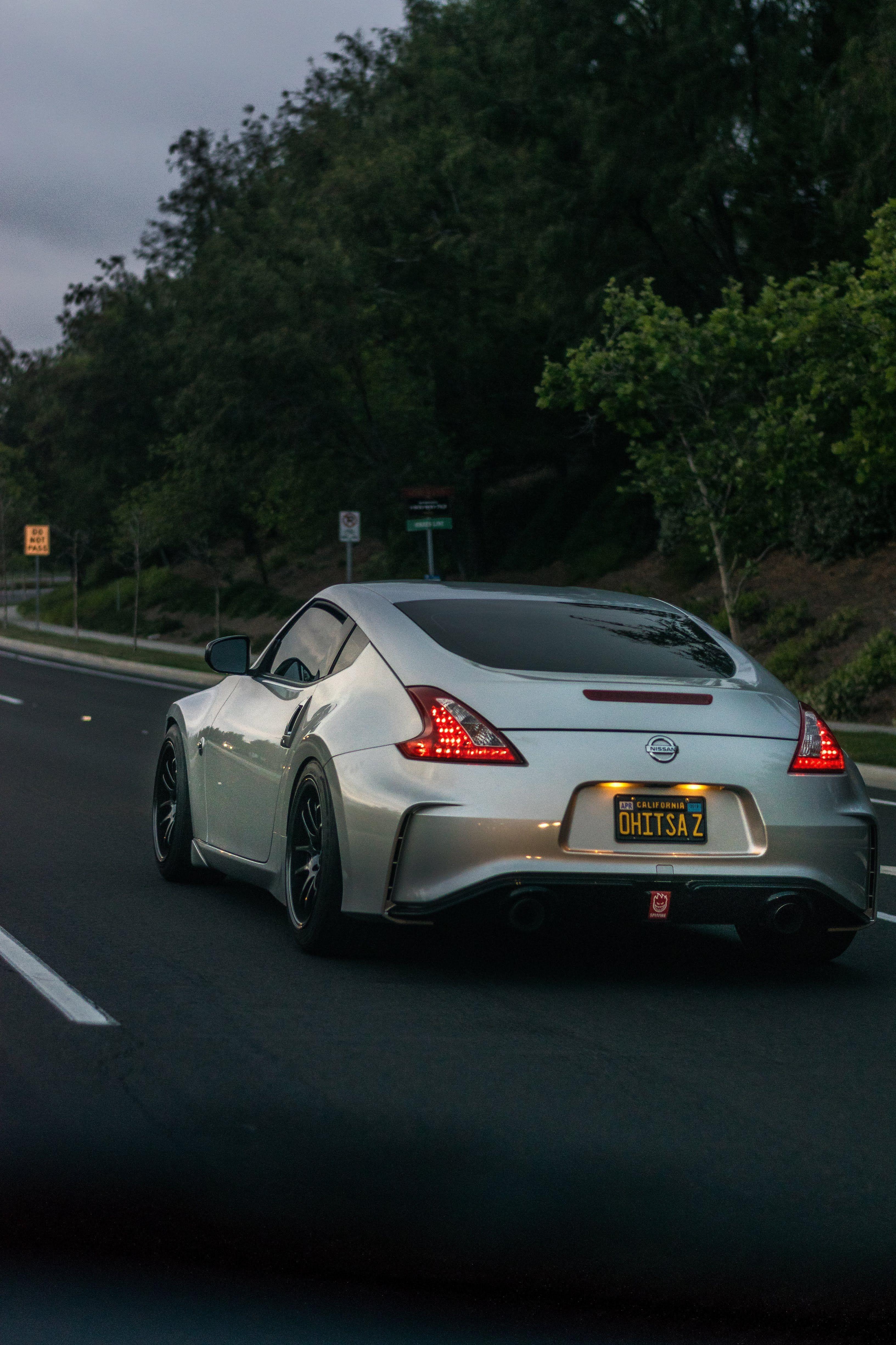 3265x4898 Download wallpaper 3265x4898 nissan 370z, silver, road, traffic HD background