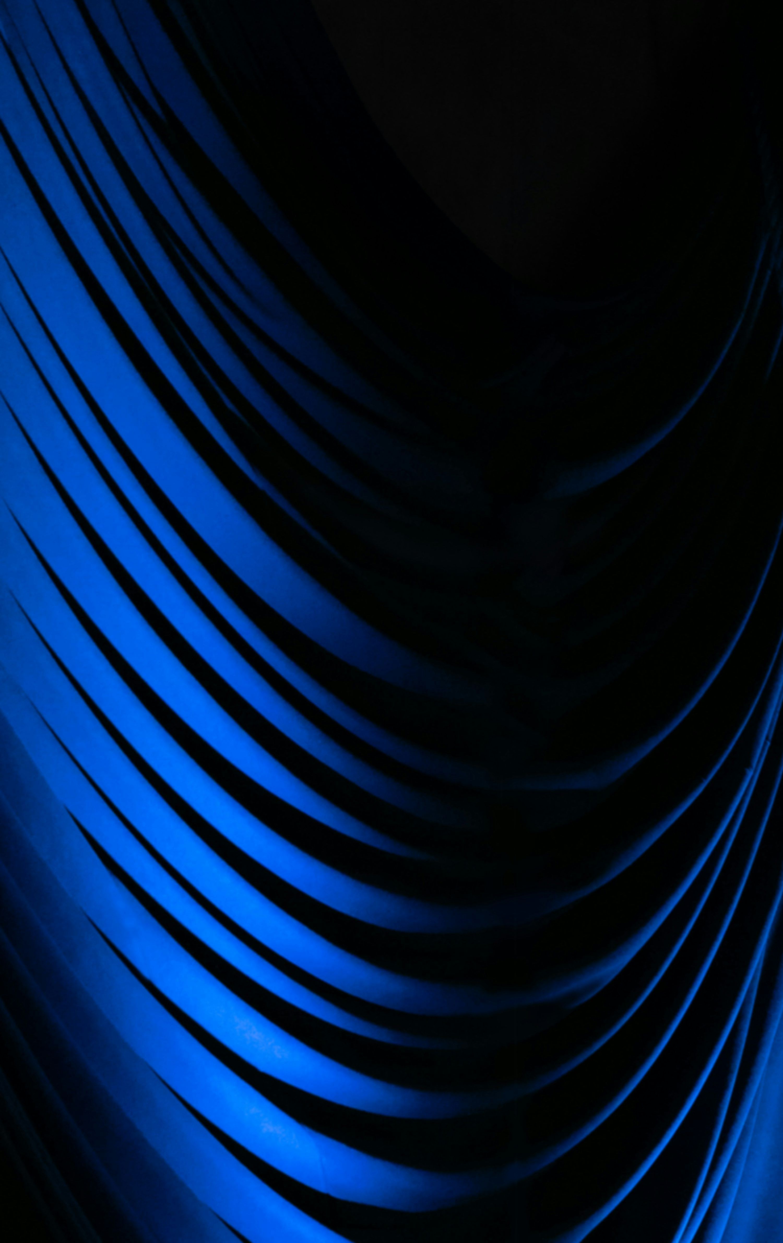 3000x4761 A black and blue background with wavy lines