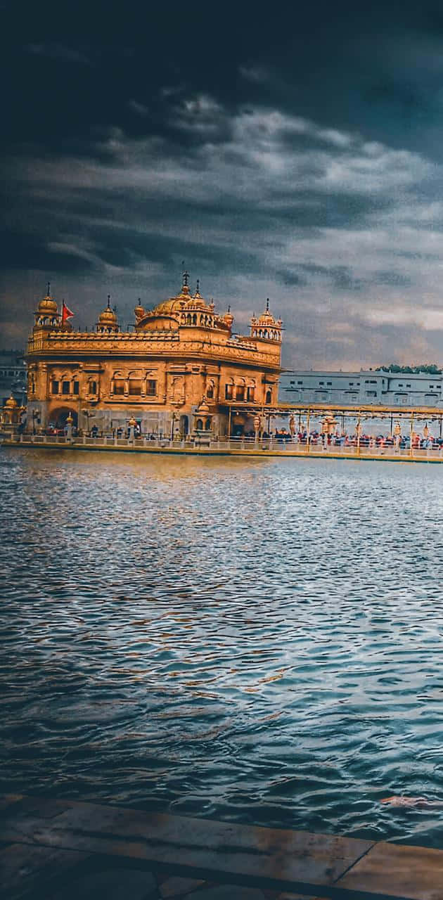 630x1280 Download Golden Temple On A Stormy Day Wallpaper