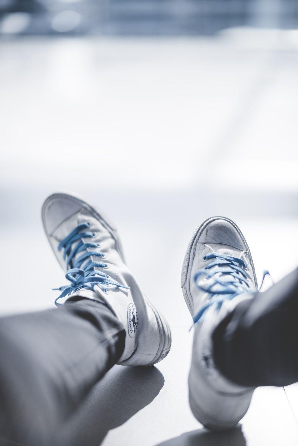 1000x1499 selective focus photography of person wearing white Chuck Taylor Converse sneakers photo