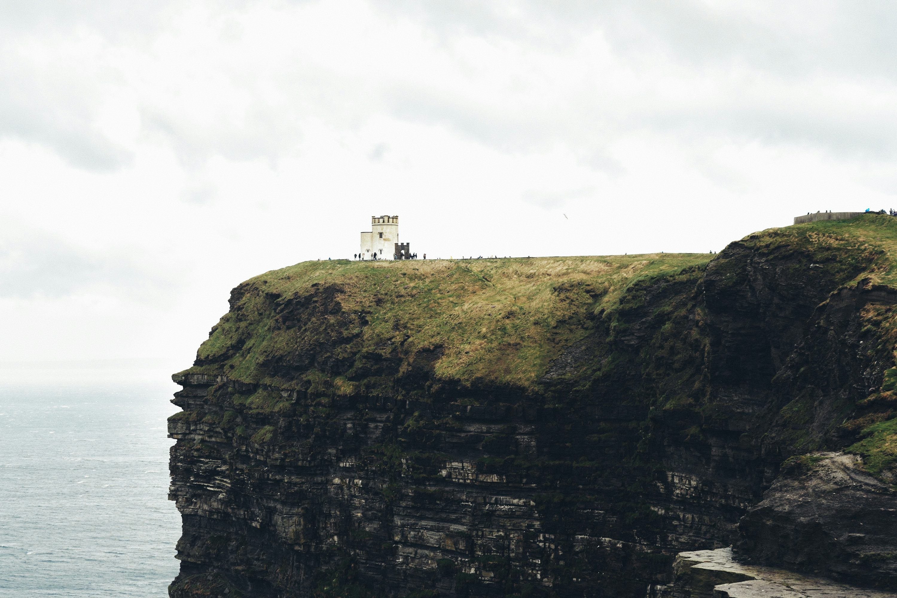 3000x2000 A scenic cliffside with a building on top