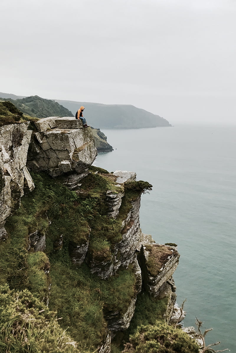 800x1195 Person sitting on cliffside during daytime, HD phone wallpaper
