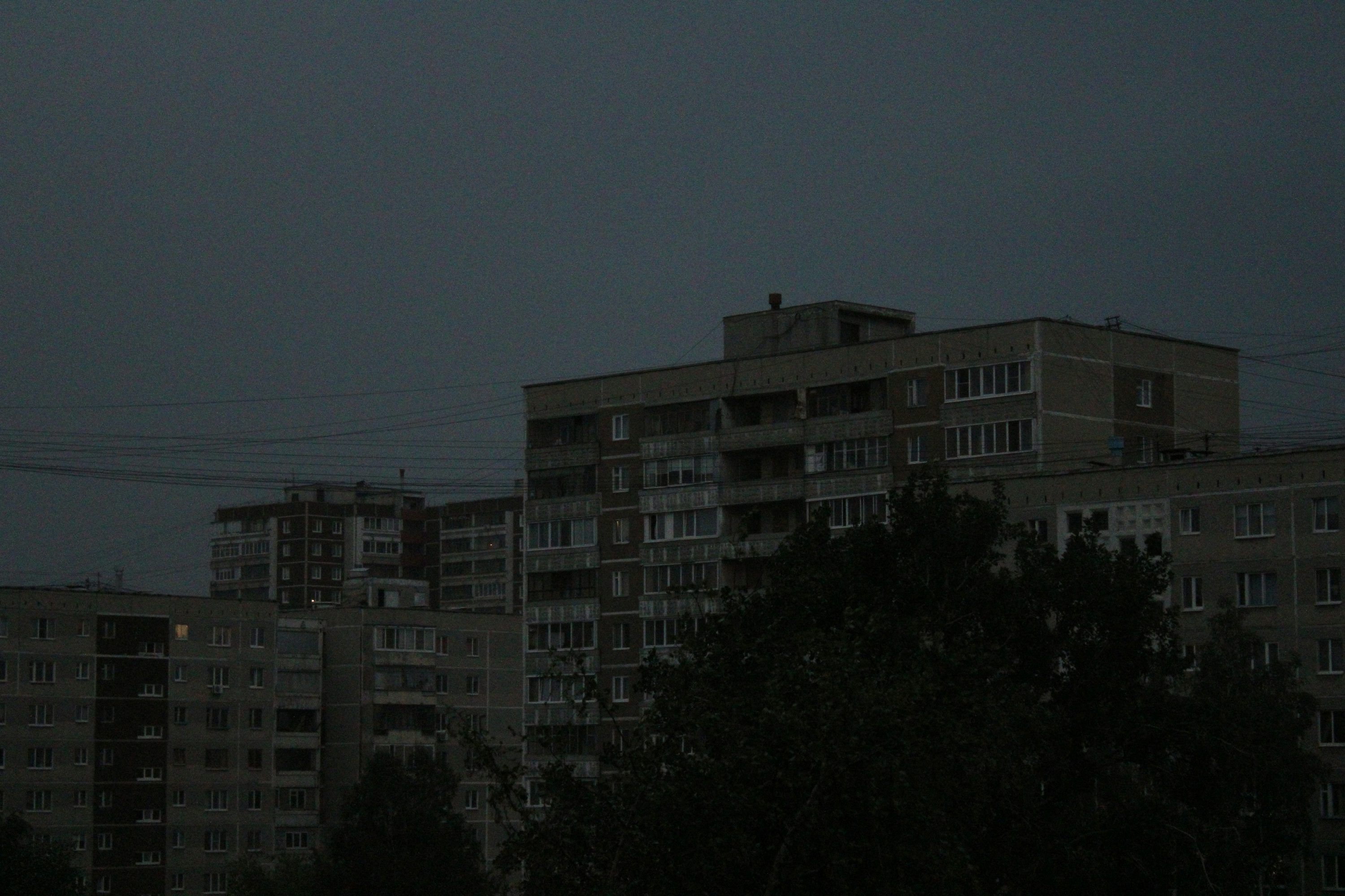 3000x2000 A full moon in the sky over a city