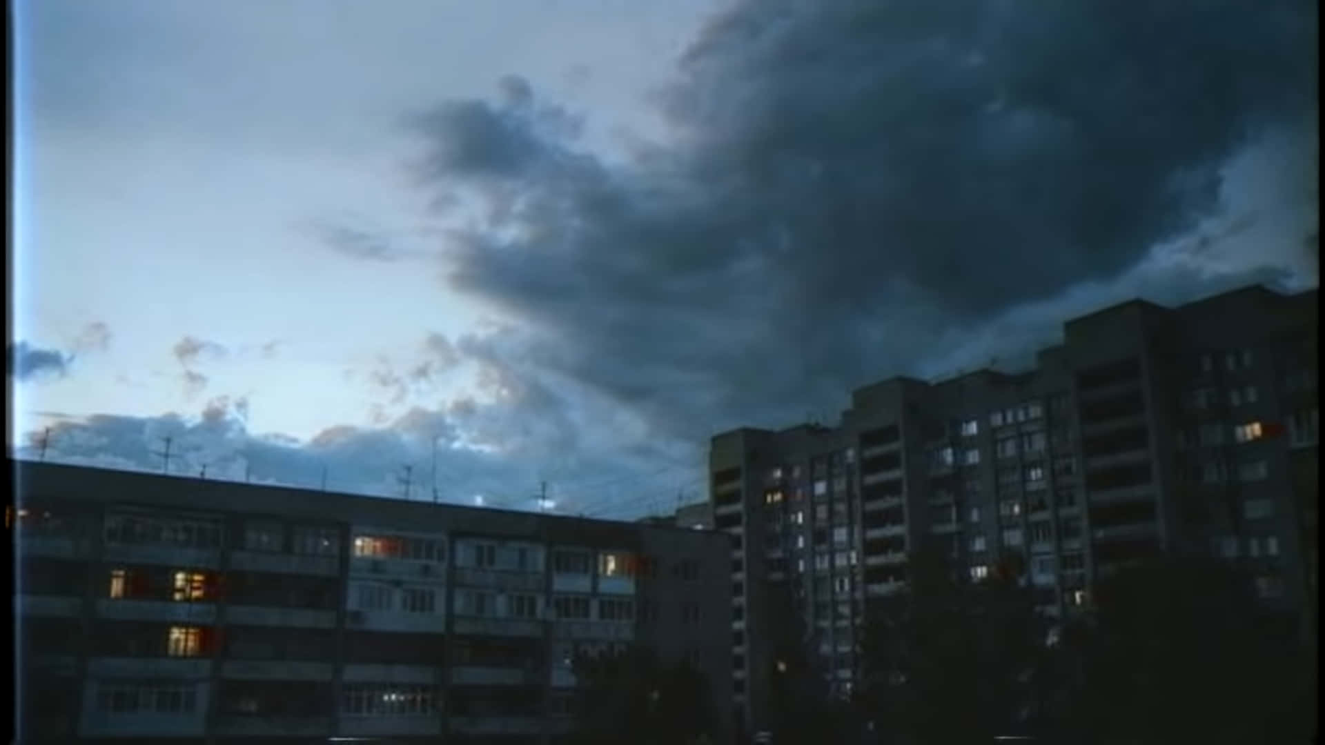 1920x1080 Download a dark sky over a city with buildings Wallpaper