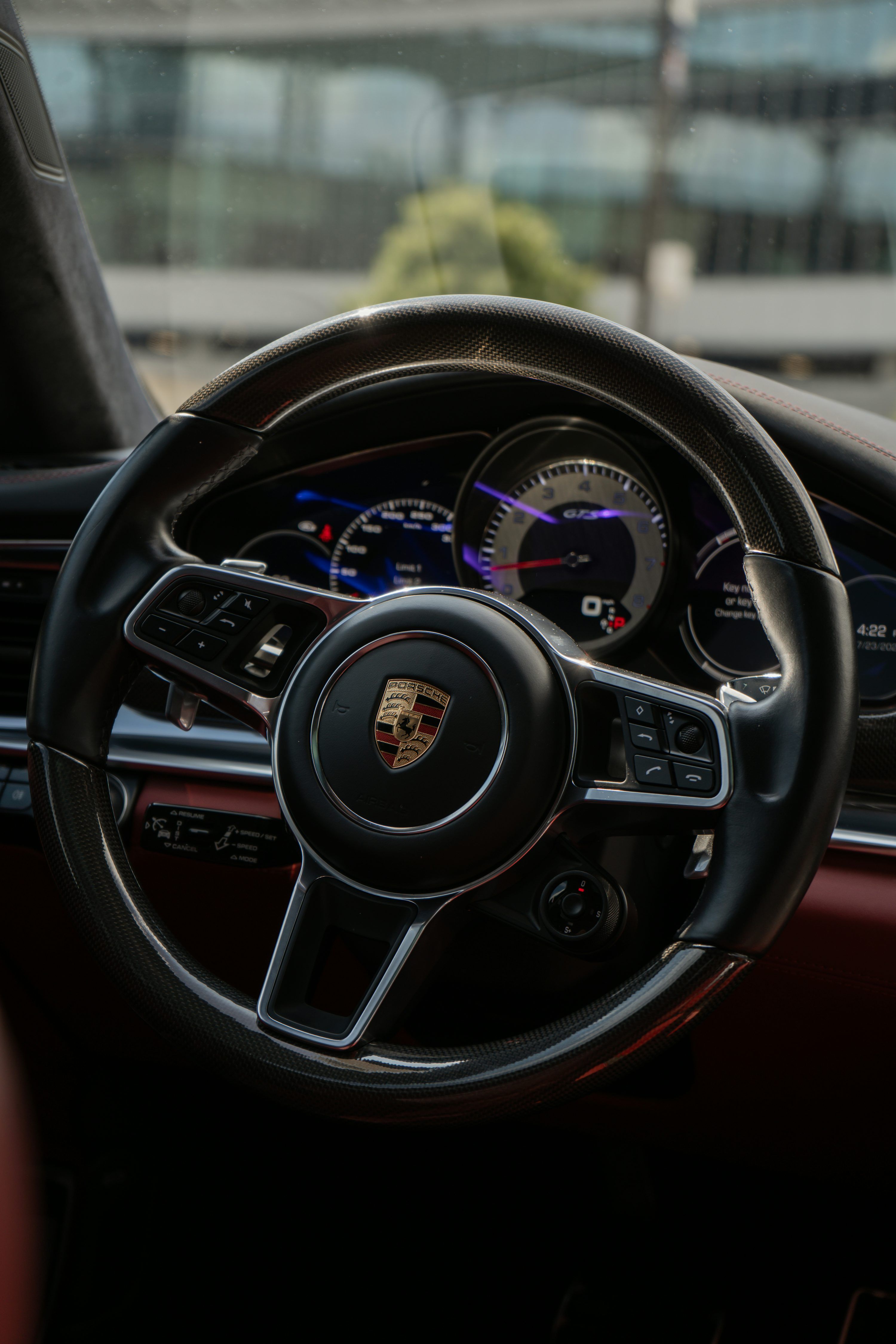 3000x4500 Porsche steering wheel in a car