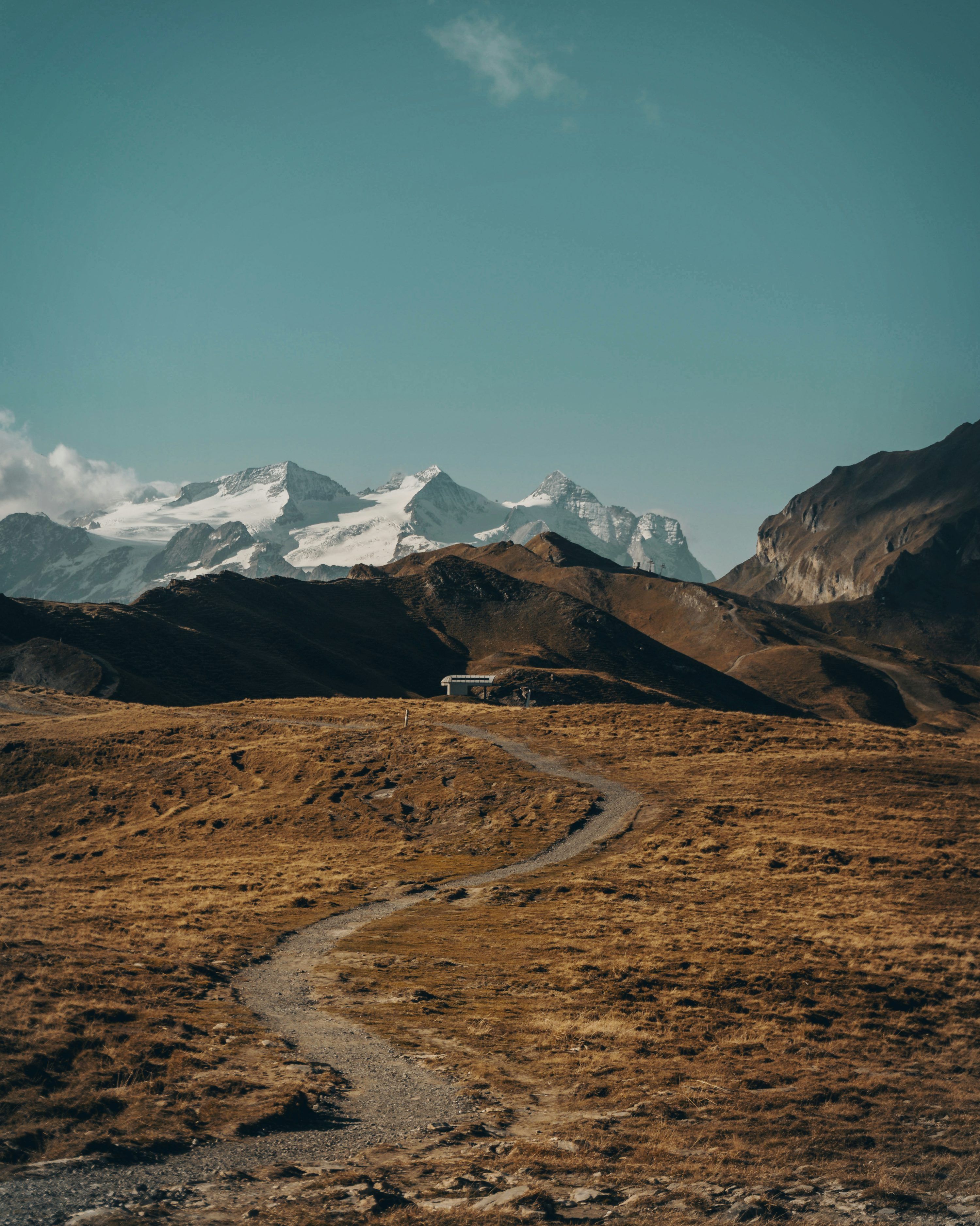 3000x3750 Dirt road between open field with mountain range in background during daytime